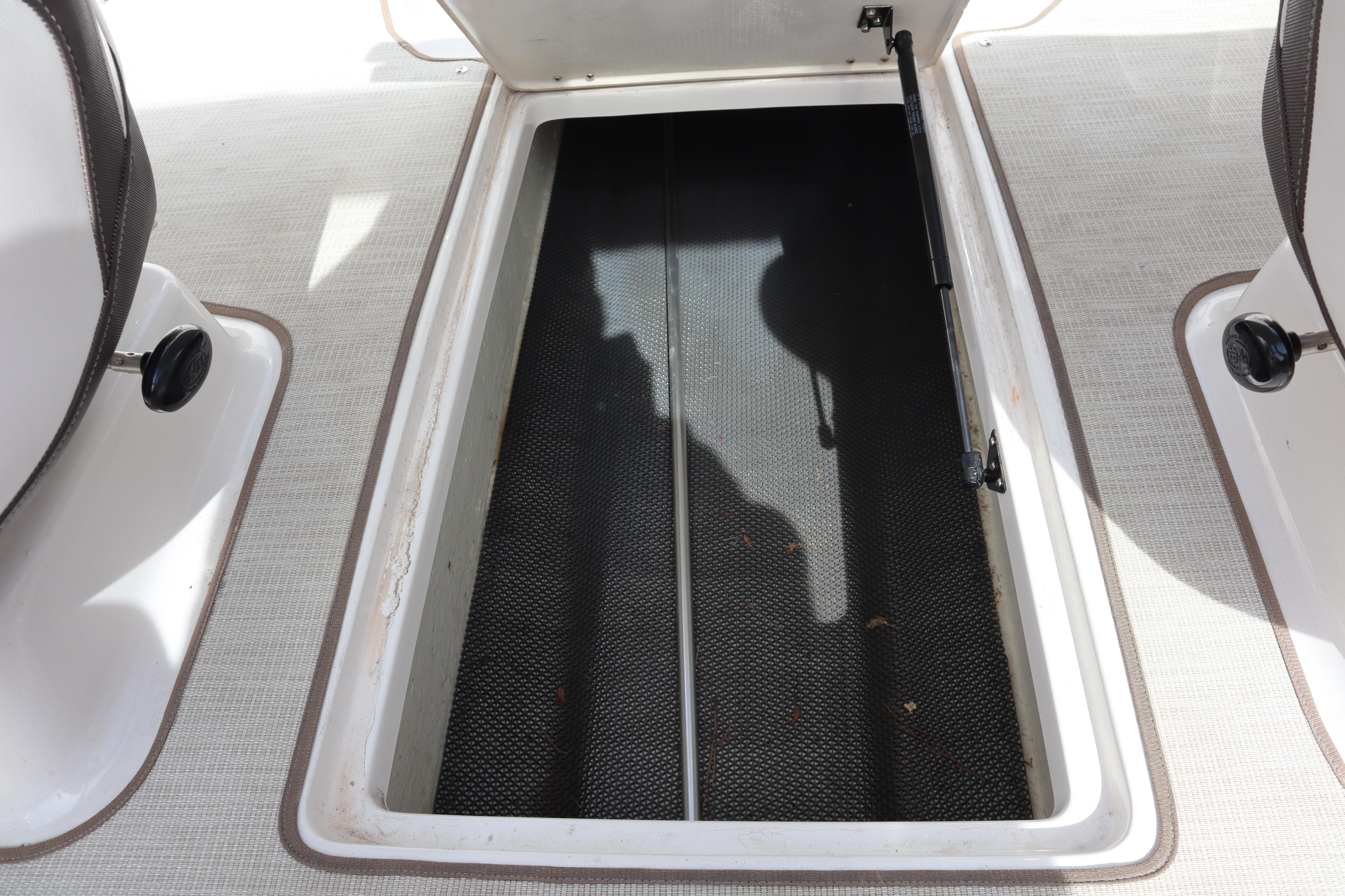 Open storage compartment on 2021 Chaparral 21 SSi boat interior.