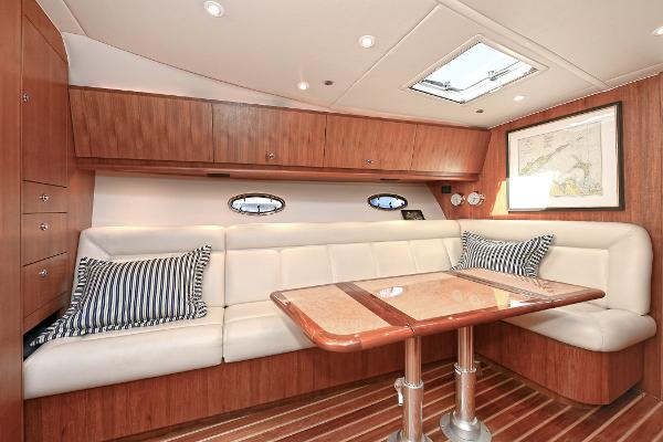 Luxurious interior of 2008 Tiara Yachts 4200 Open with elegant seating and wooden finishes.