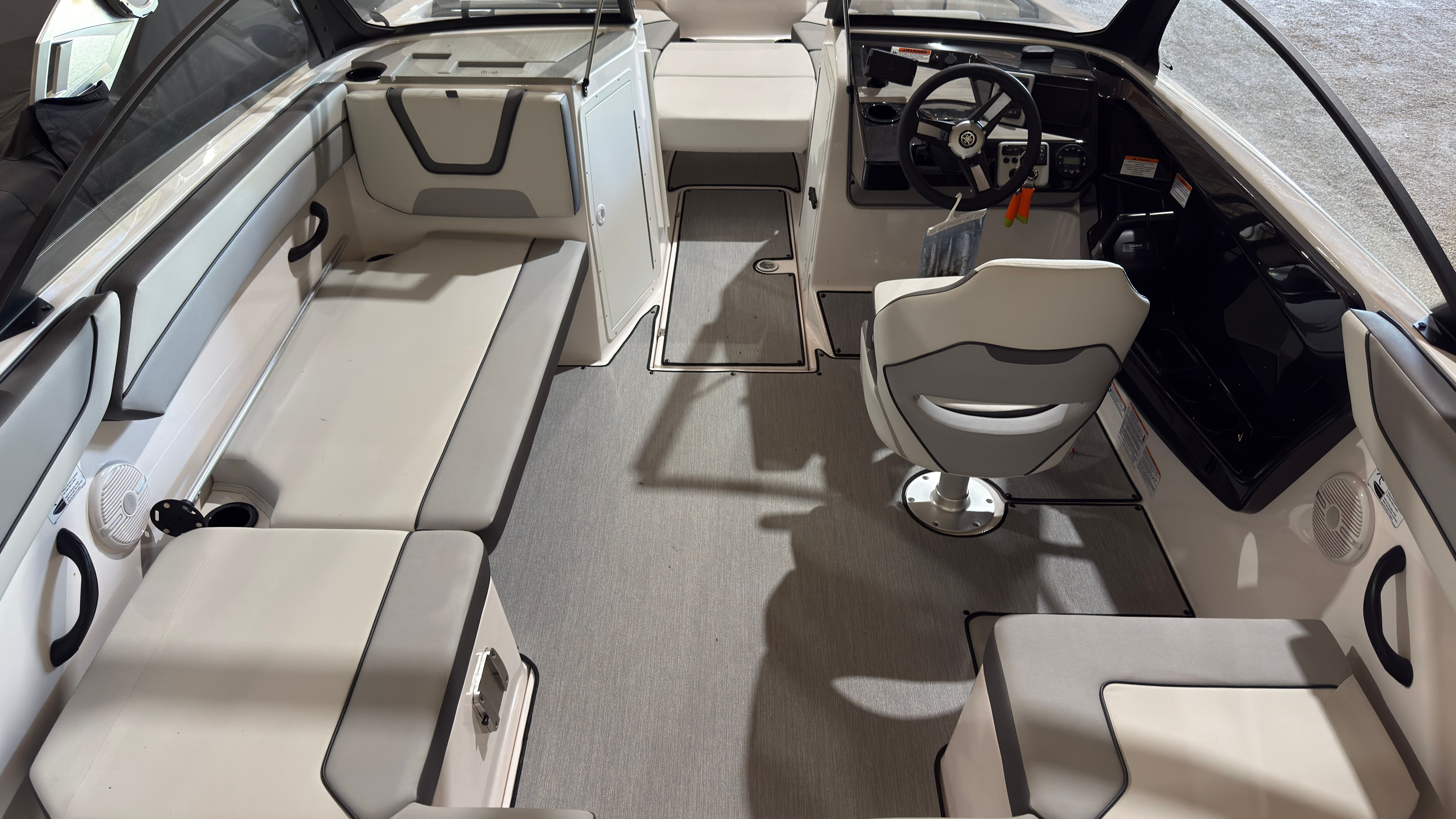 Interior of 2024 Yamaha Boats AR220 with gray seating and helm console.