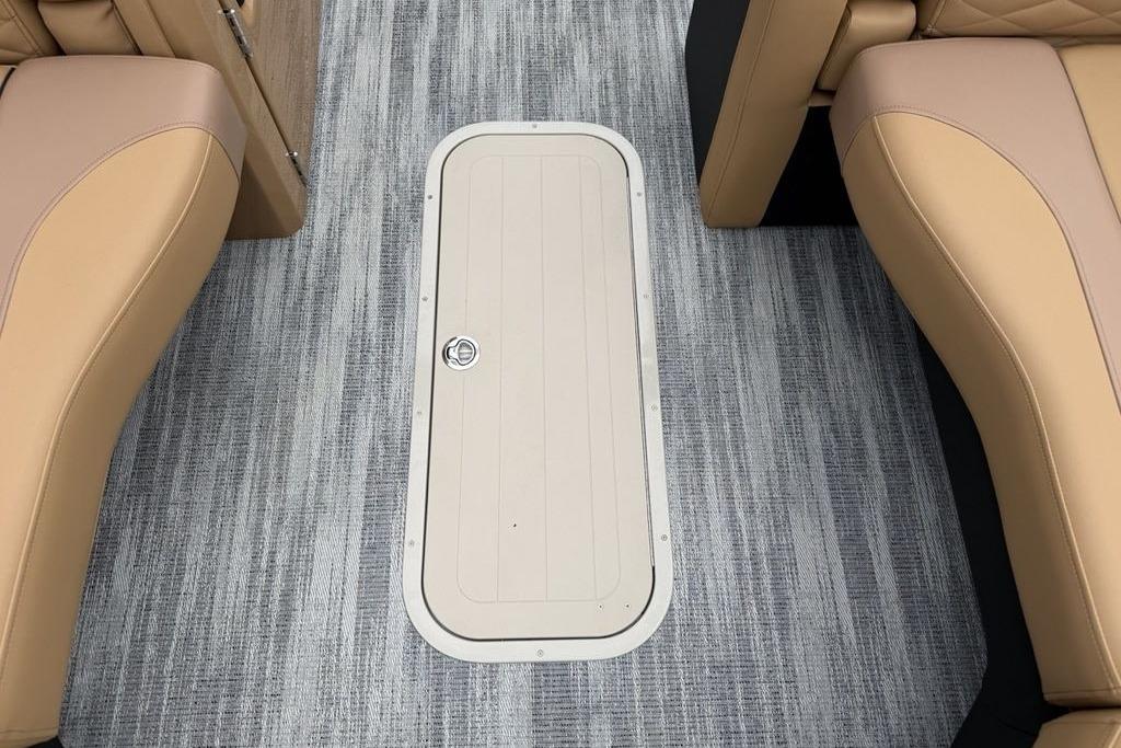 Interior view of 2026 Godfrey Monaco 235 SFLC iMPACT boat with beige seating and floor hatch.