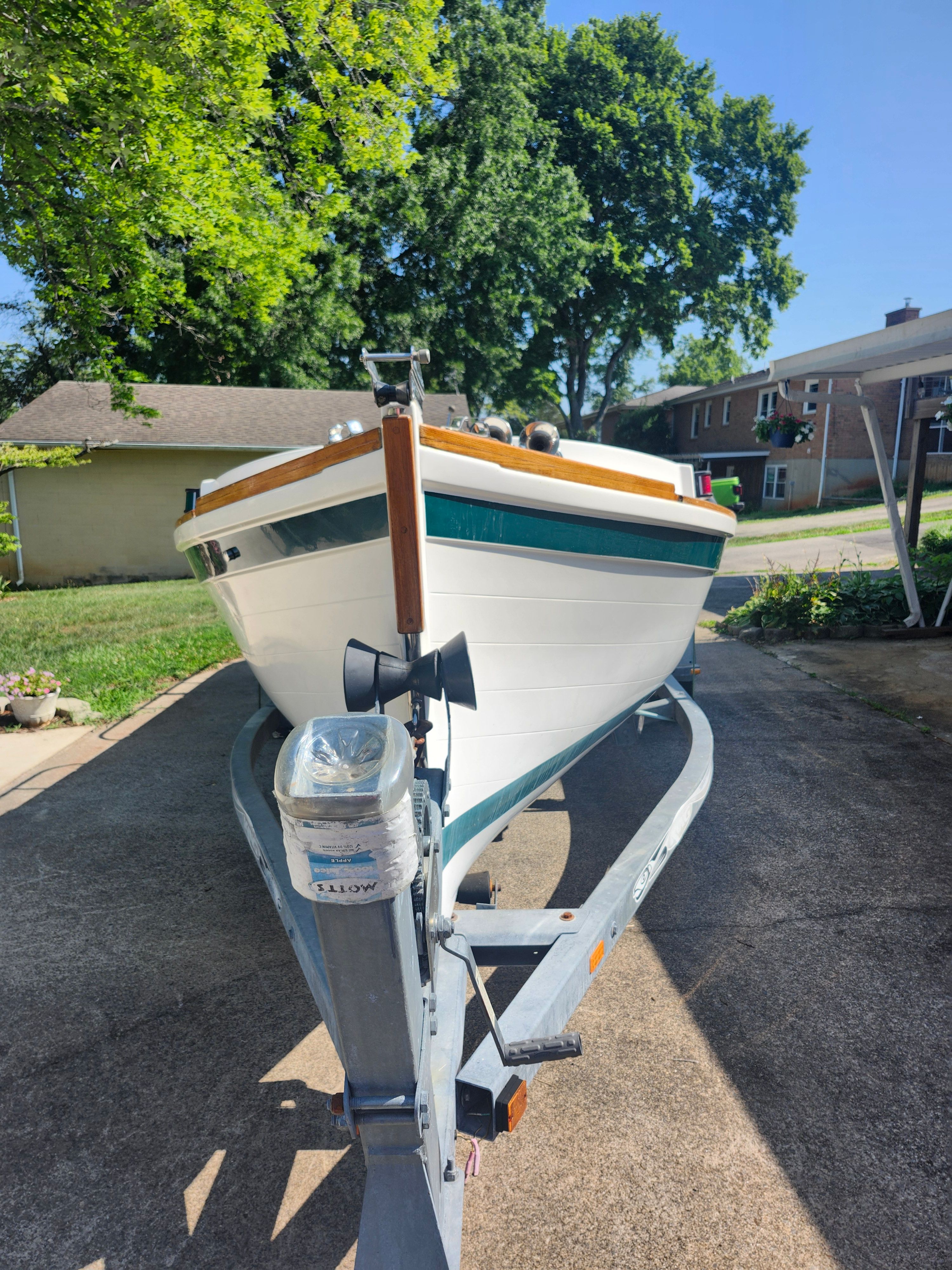 Ranger Tugs Martini 21 Launch from 2000 on a trailer in a residential area.