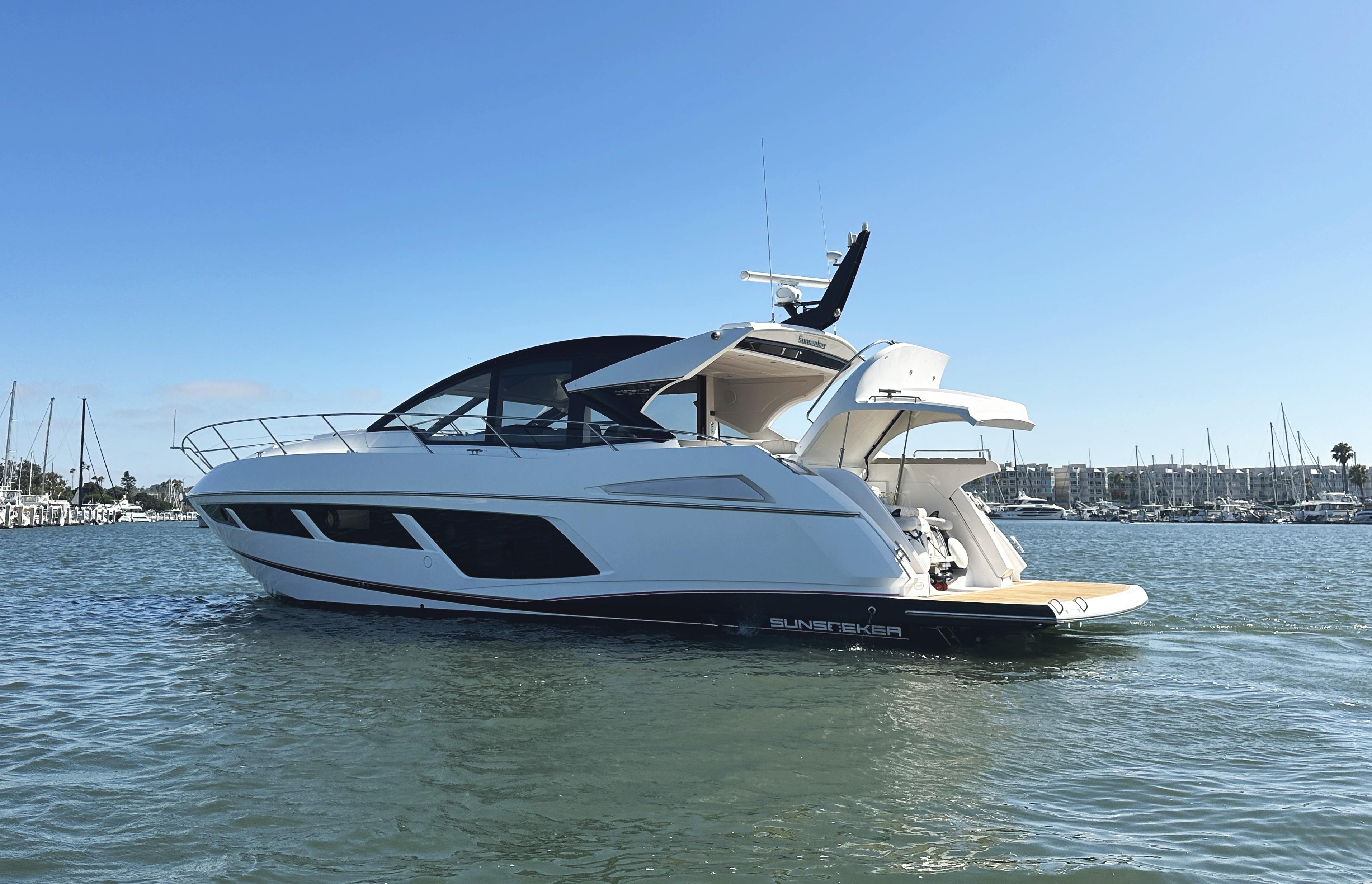 2019 Sunseeker Predator 57 yacht on calm water, clear sky background.