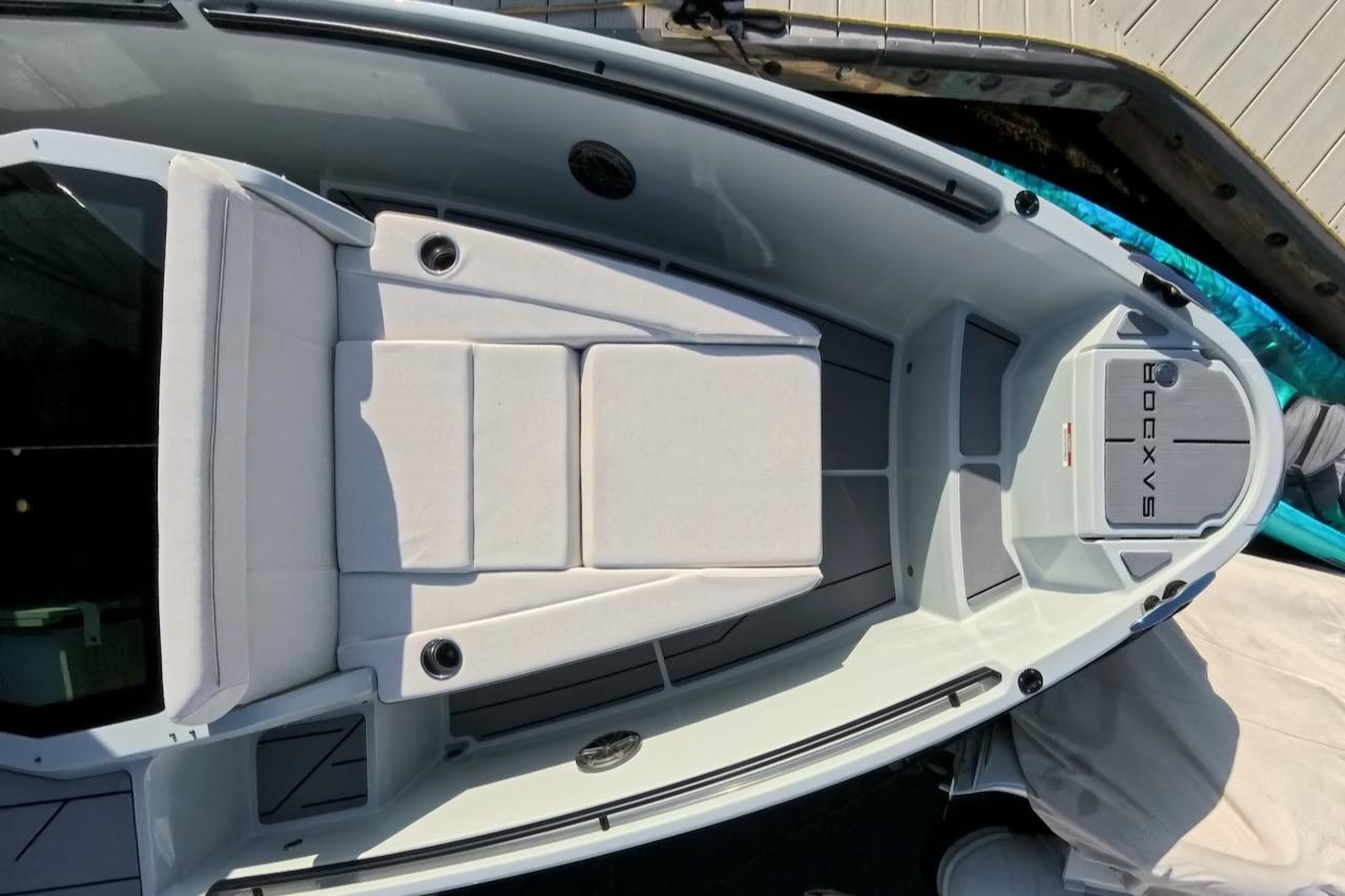 2024 Saxdor 320 GTC boat deck with cushioned seating and sleek design.