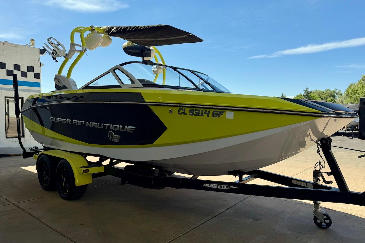 2014 Nautique Super Air Nautique G21 boat on trailer, vibrant yellow and black design.