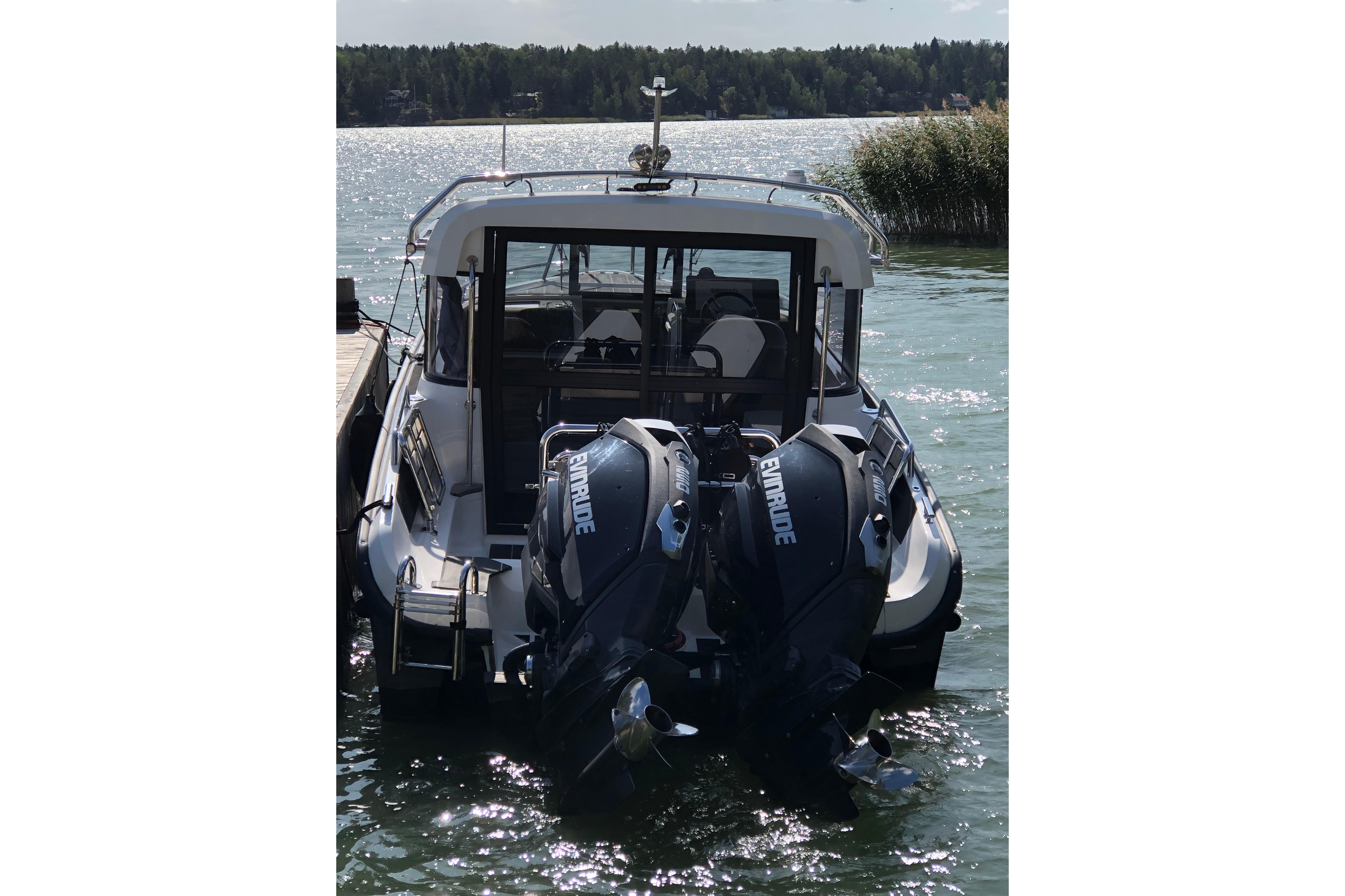 2016 XO Boats 270 RS with dual Evinrude engines docked on a sunny day.