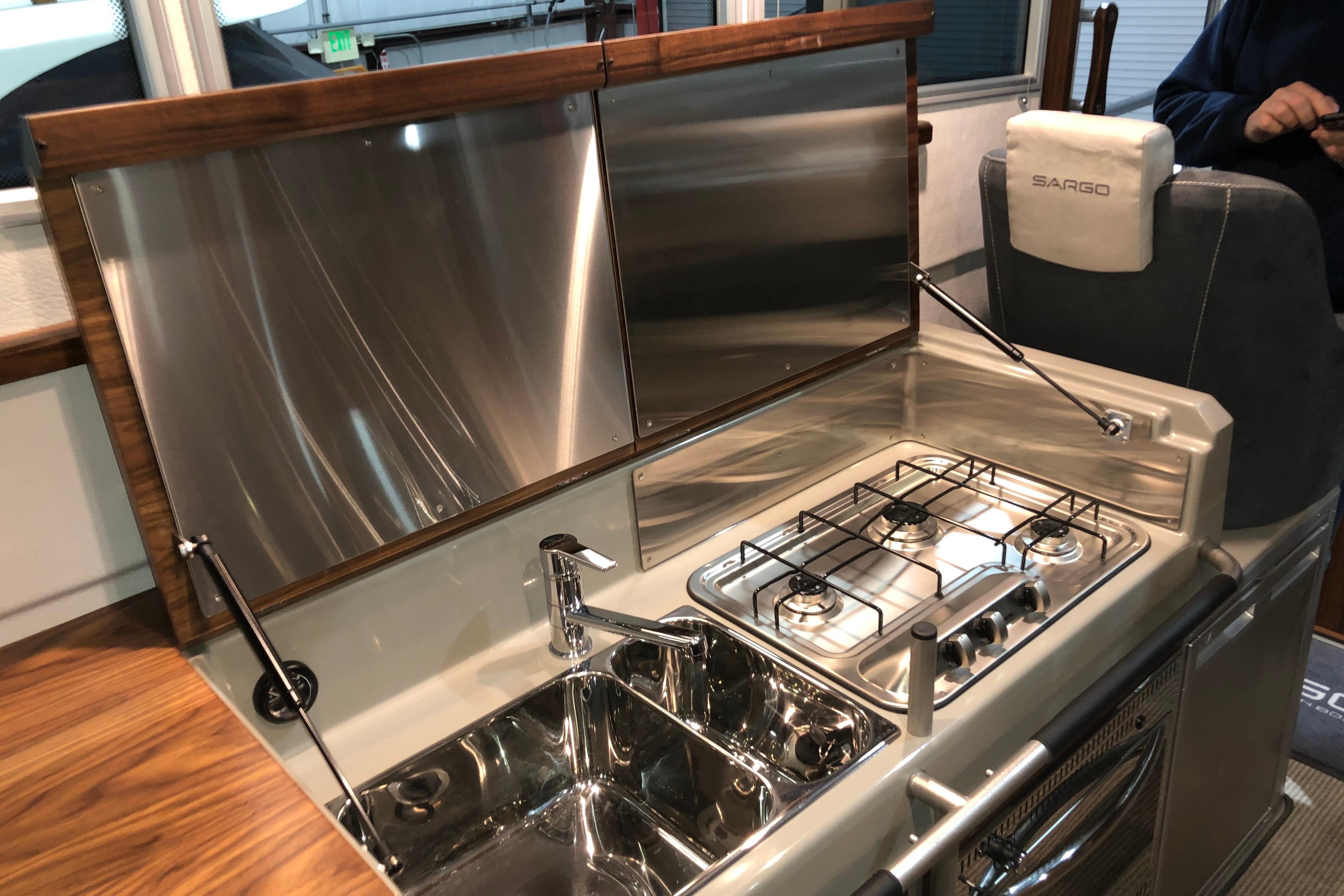 Modern kitchen area in 2019 Sargo 36 Explorer boat with stove and sink.