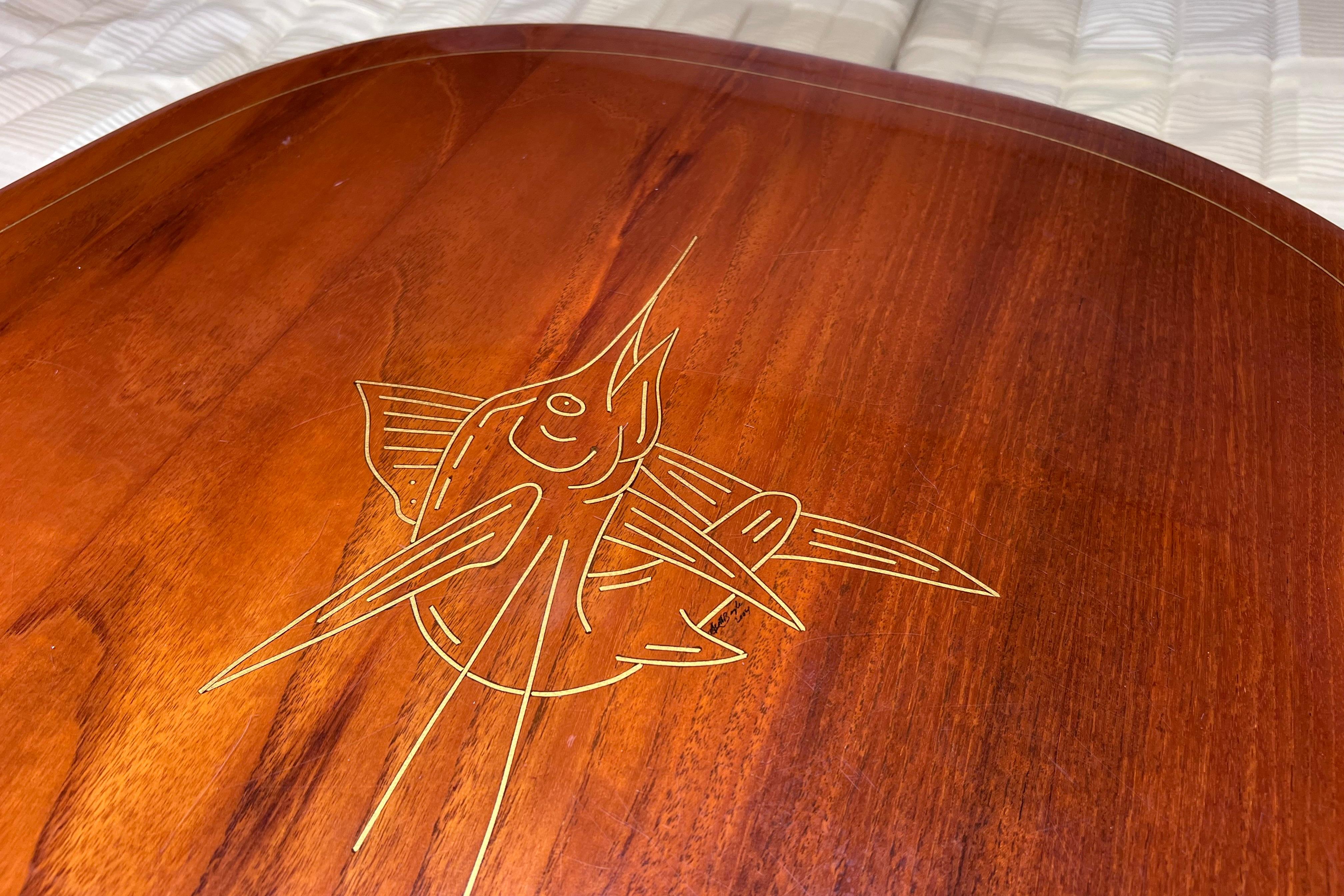 Wooden table with engraved marlin design on a 2005 Pursuit 3070 Offshore boat.