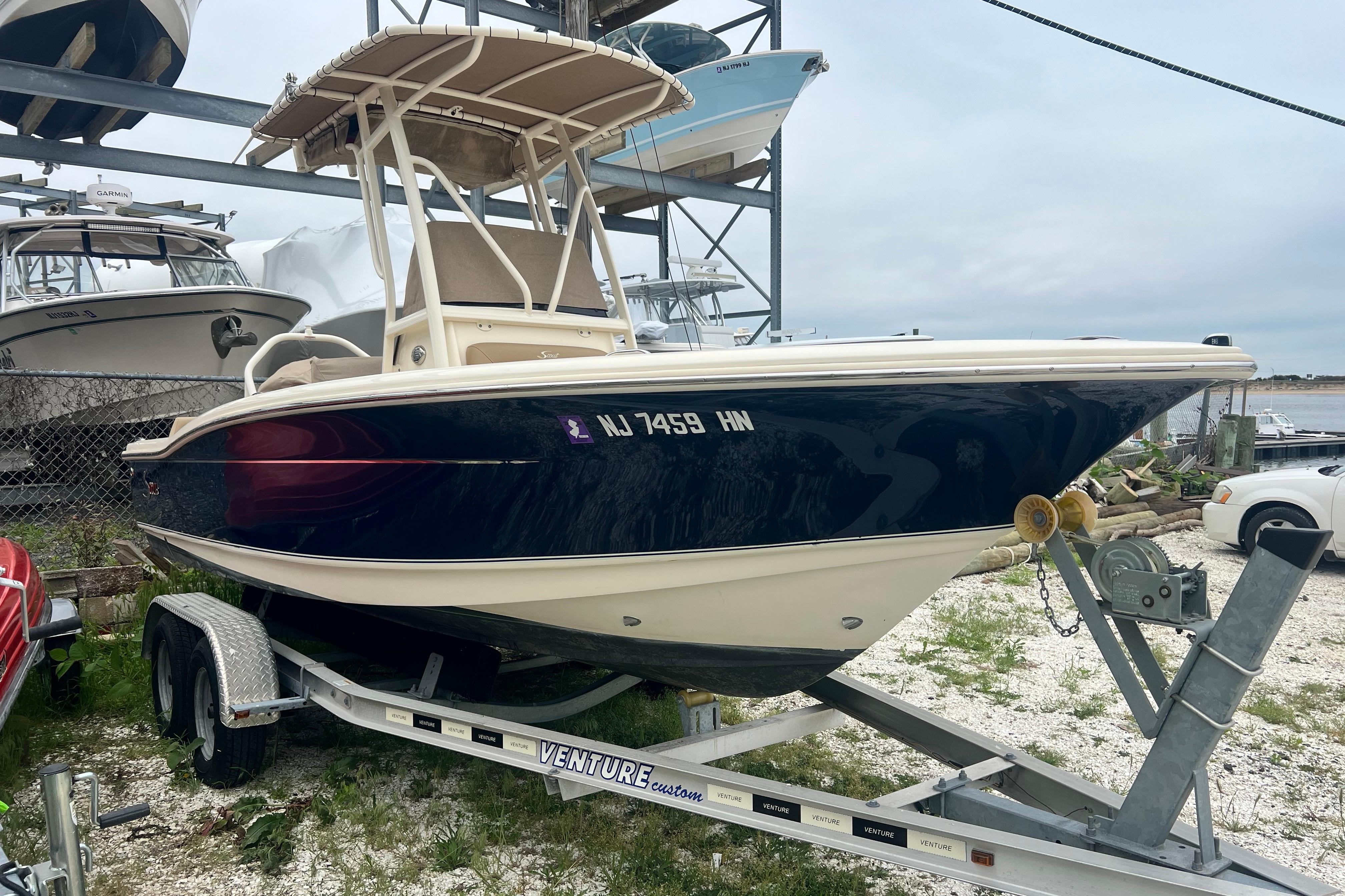 2020 Scout 195 Sportfish boat on trailer, parked outdoors.