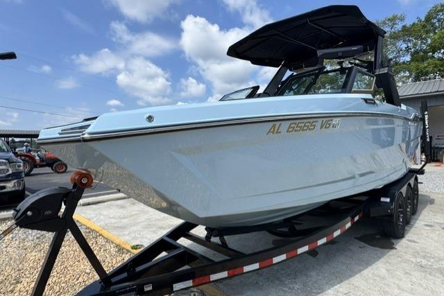 2026 MasterCraft XStar 25 boat on trailer under blue sky.