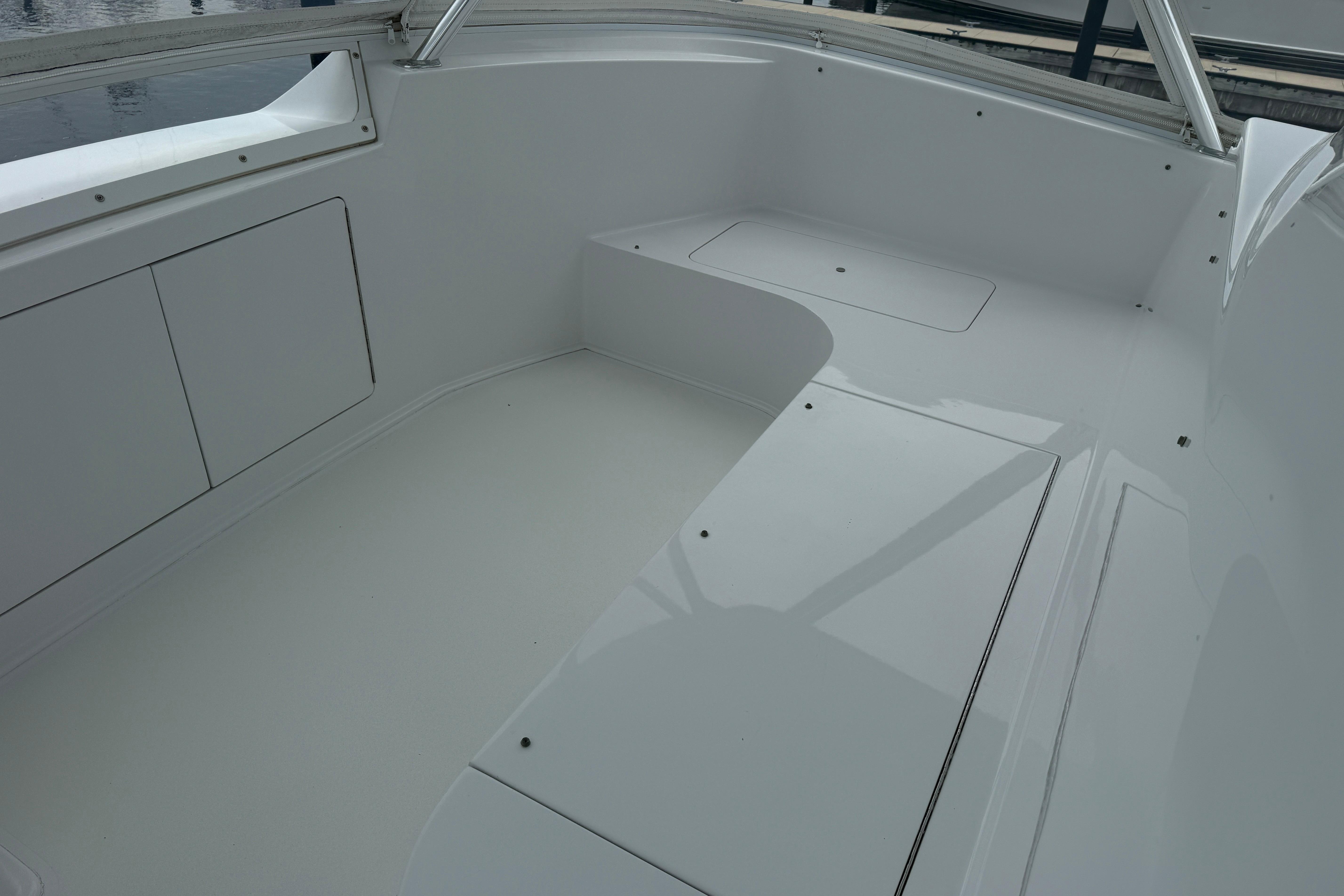 Spacious deck area of a 2000 Viking 55 Convertible yacht, featuring sleek white surfaces.