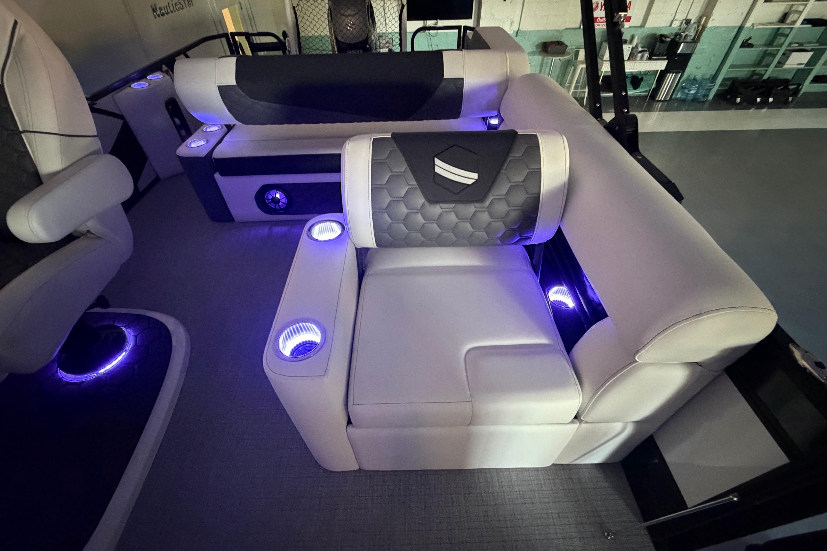Luxurious interior of 2026 South Bay 525SB2 boat with illuminated seating and cup holders.