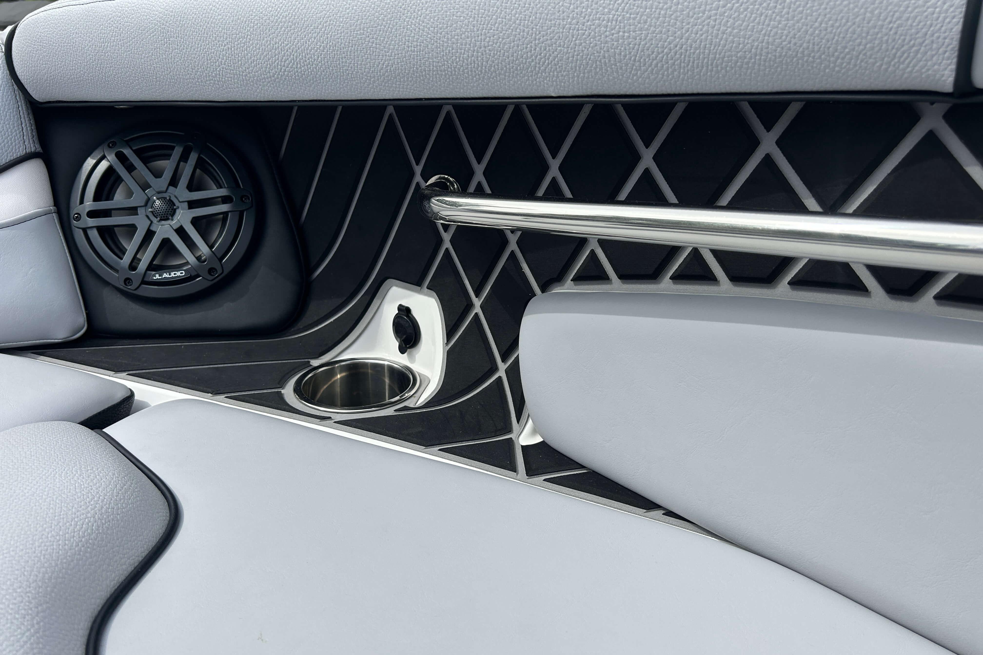 Interior of 2021 Nautique Super Air Nautique GS24 with speaker, cup holder, and sleek design.