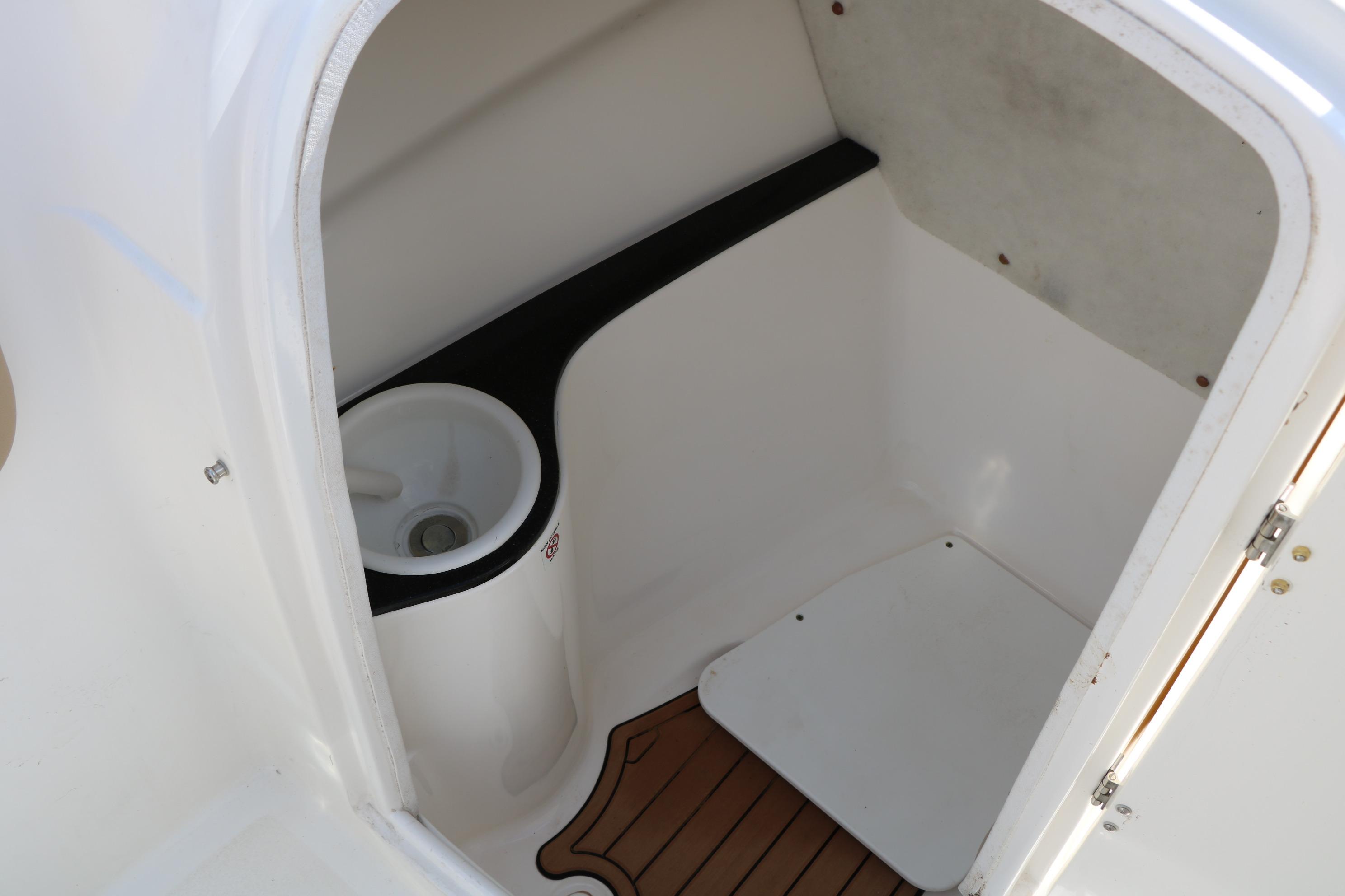 2017 Sea Fox 226 Traveler boat interior with compact storage space and wooden flooring.