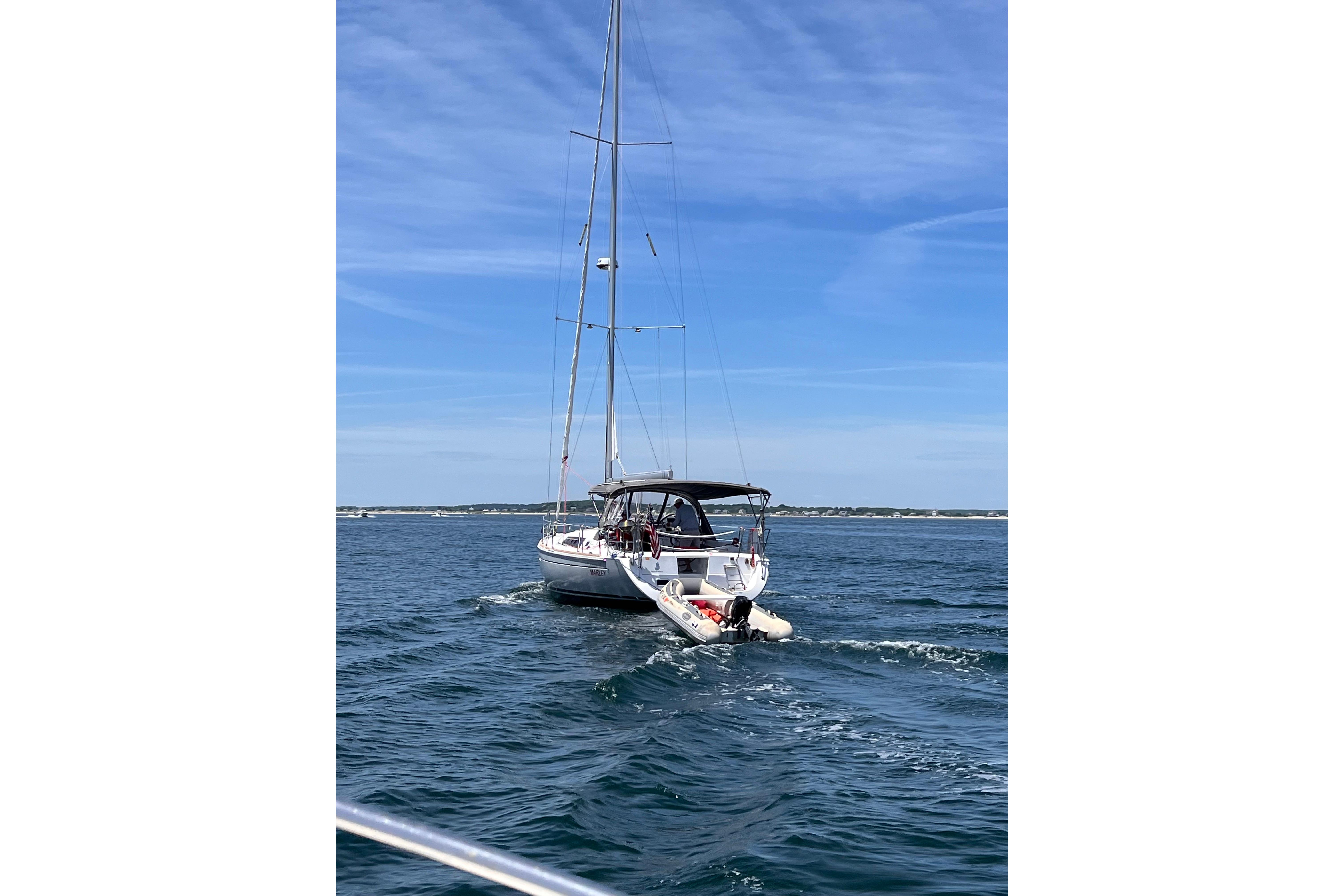 2015 Beneteau Oceanis 37 sailboat cruising on open water under a clear blue sky.