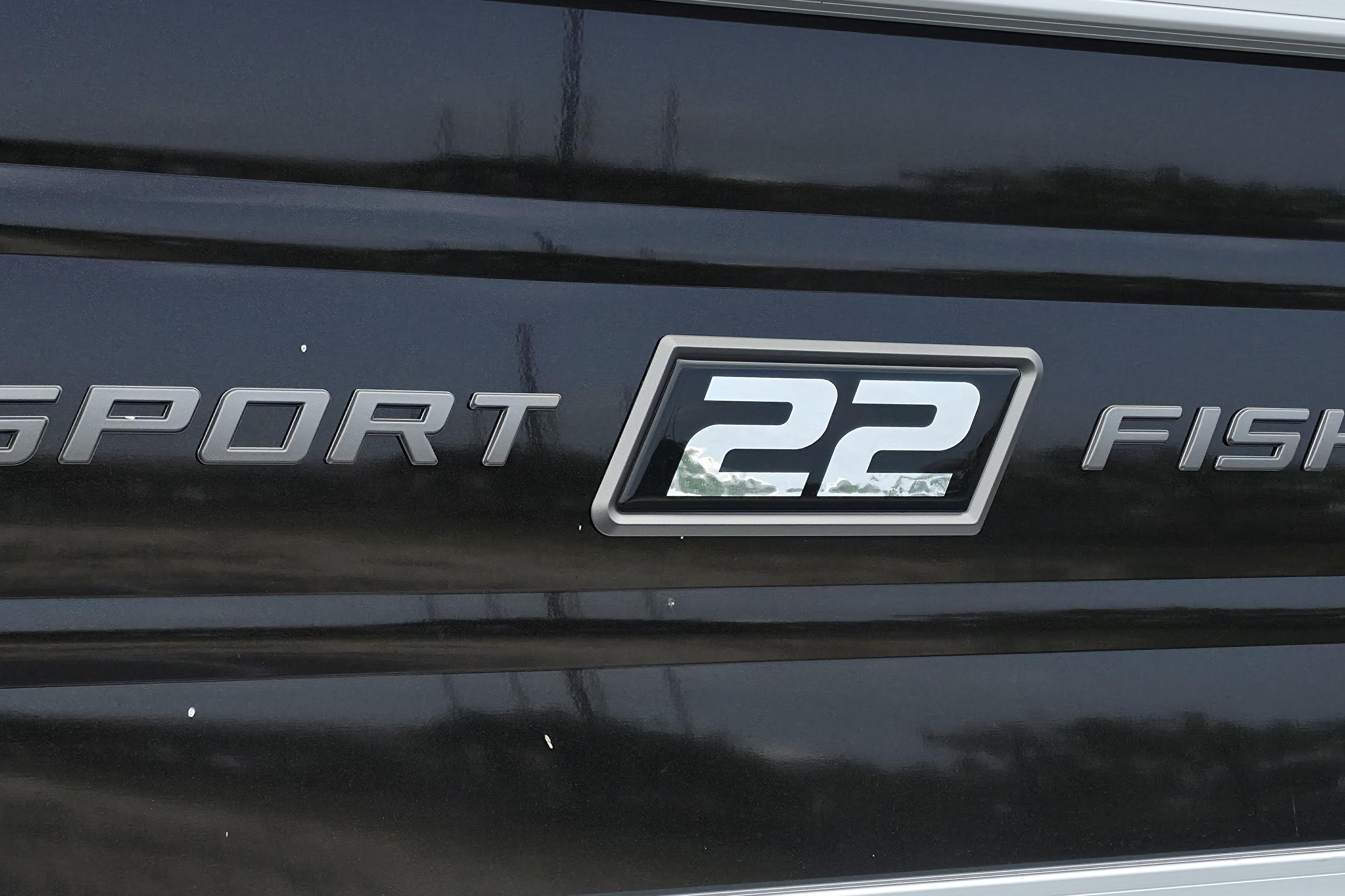 2026 Sun Tracker SportFish 22 XP3 logo on black surface.