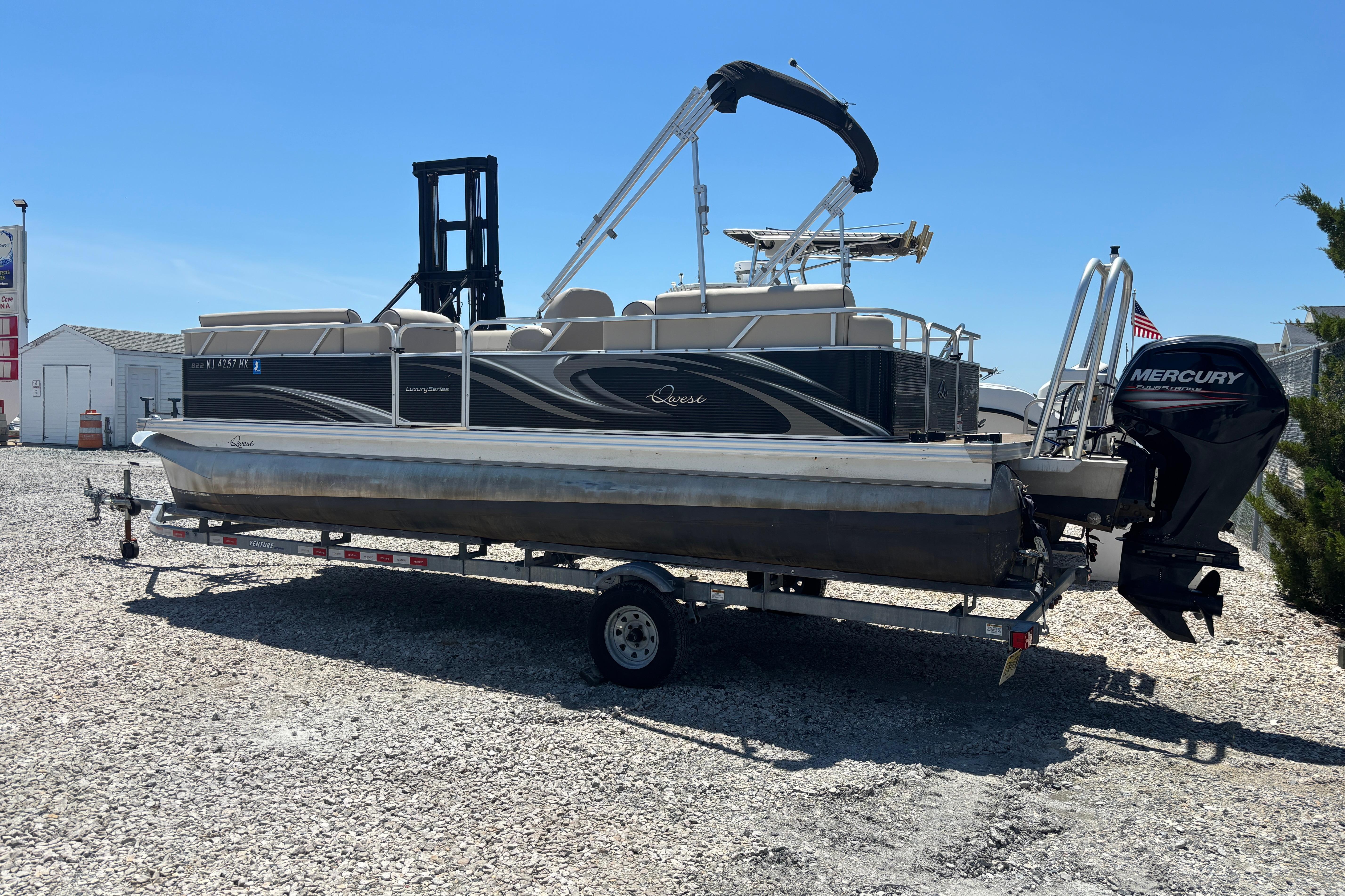 2017 Qwest LS 822 Bar pontoon boat on trailer with Mercury outboard motor.