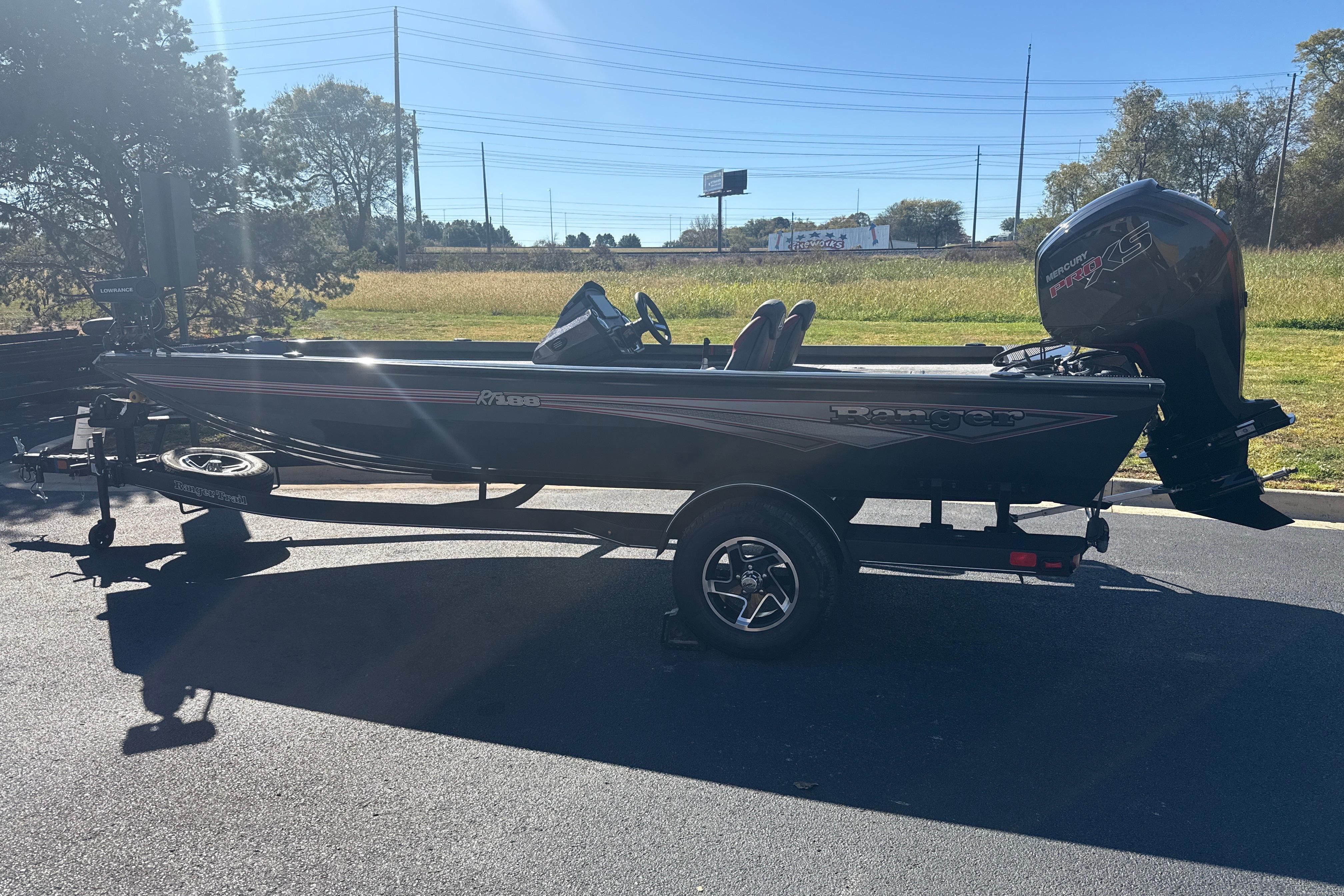 2025 Ranger RT188 boat with Mercury engine on a trailer, parked outdoors.