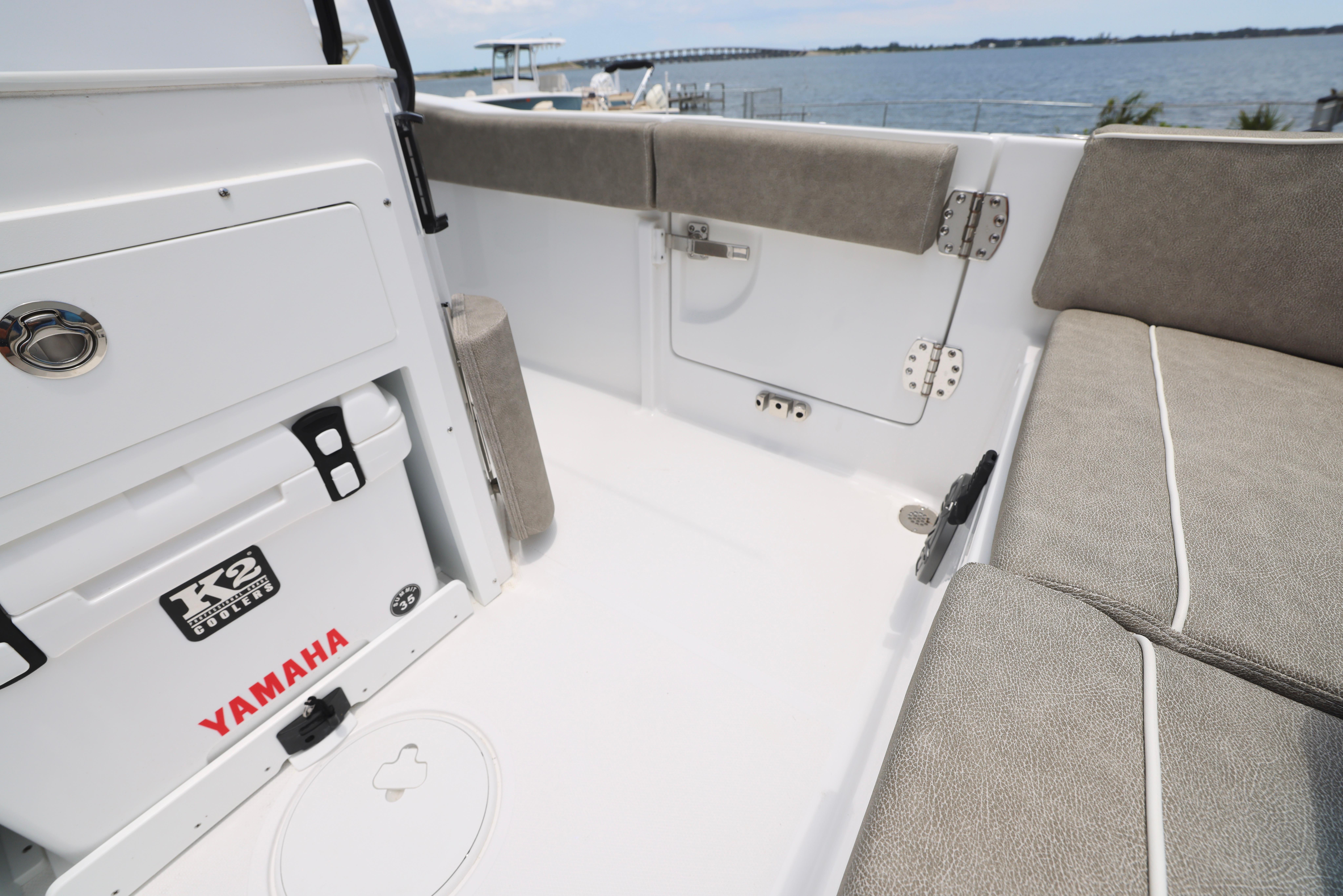 Interior of 2026 Sea Hunt Ultra 245 SE boat with seating and cooler.