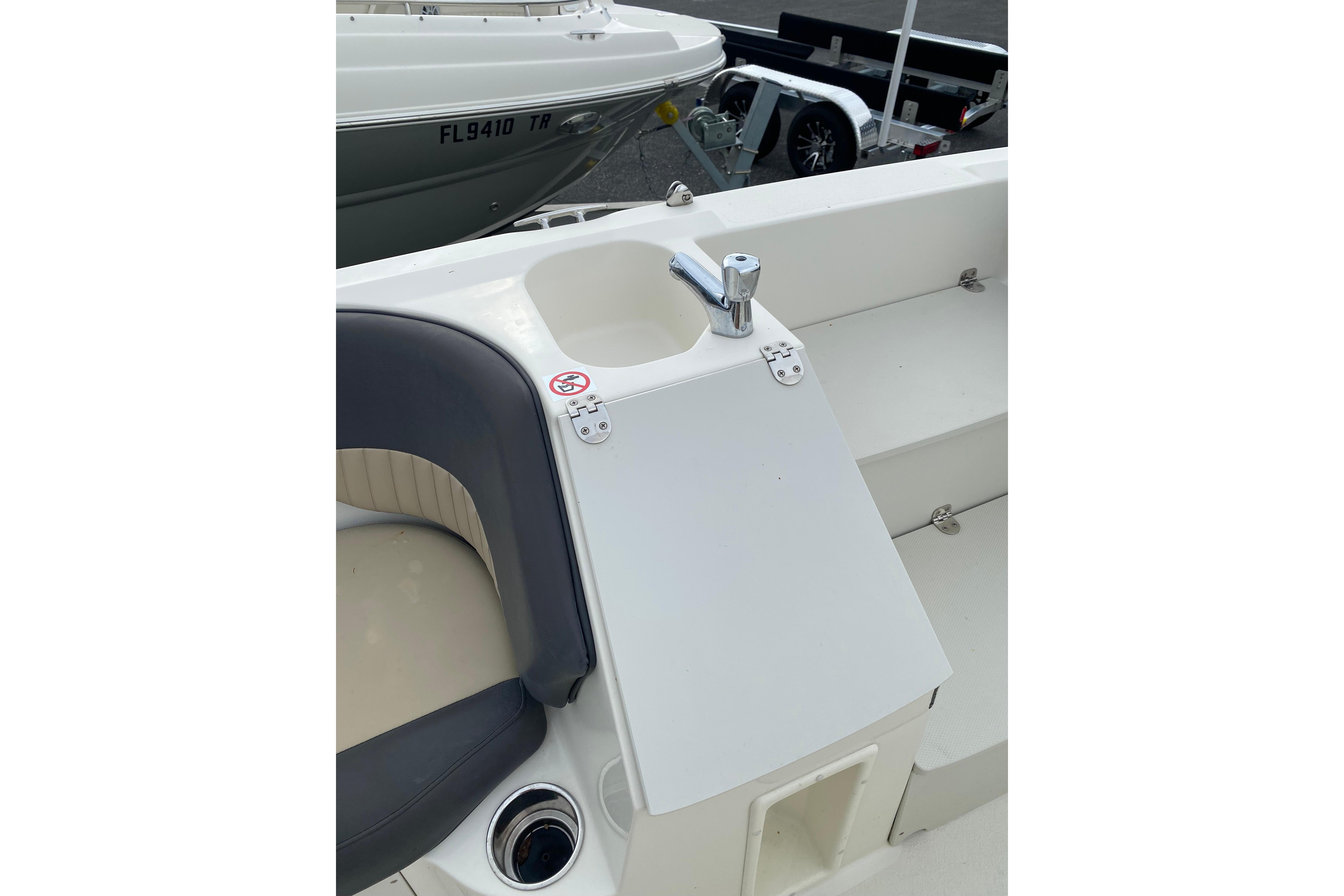 2018 Stingray 212 SC boat interior with seating and sink area.