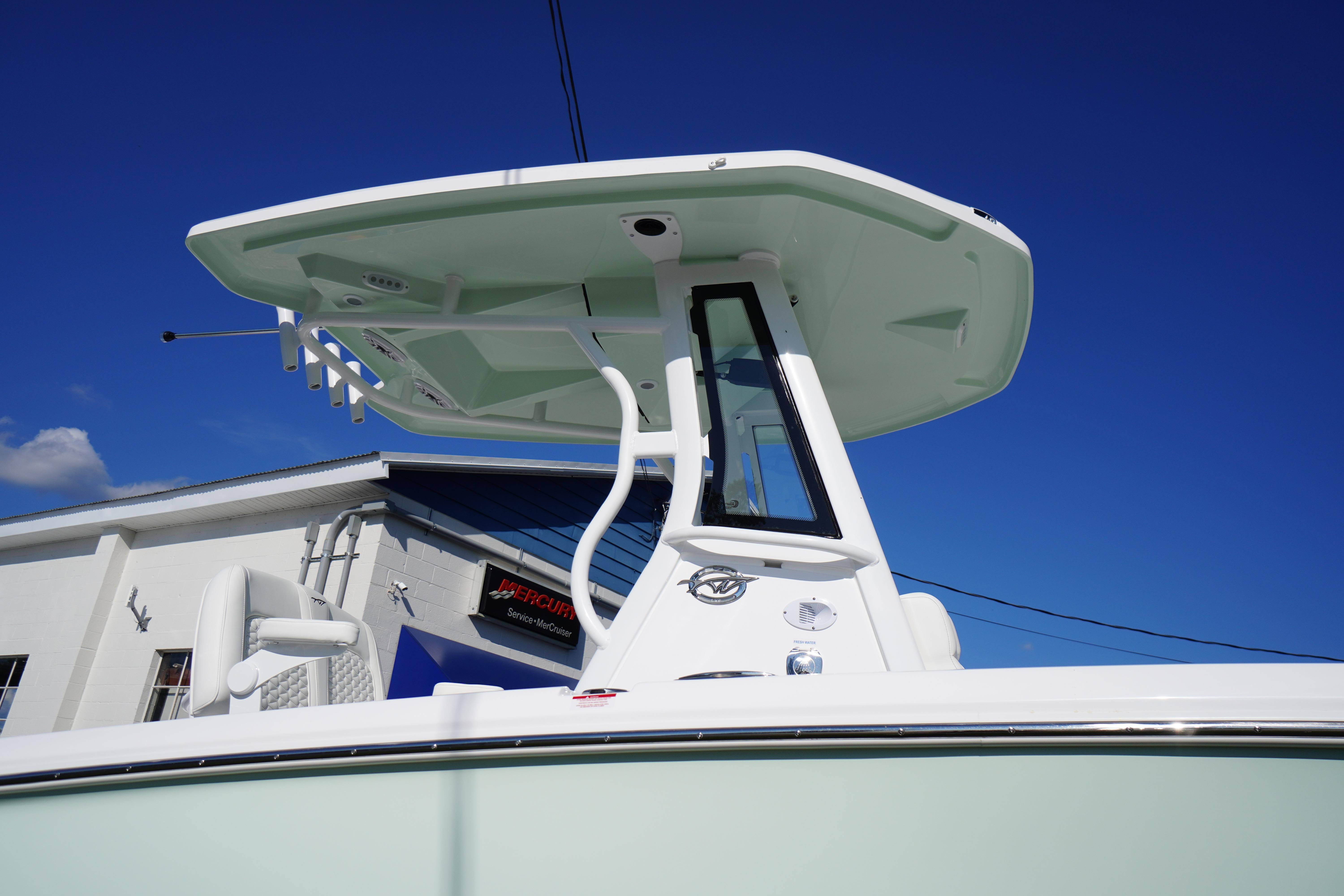 2026 Tidewater 272 LXF boat with T-top against clear blue sky.