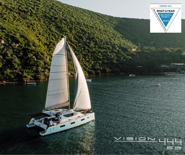 Sailing catamaran Vision 444 gliding through scenic waters, surrounded by lush green hills, 2026 model.