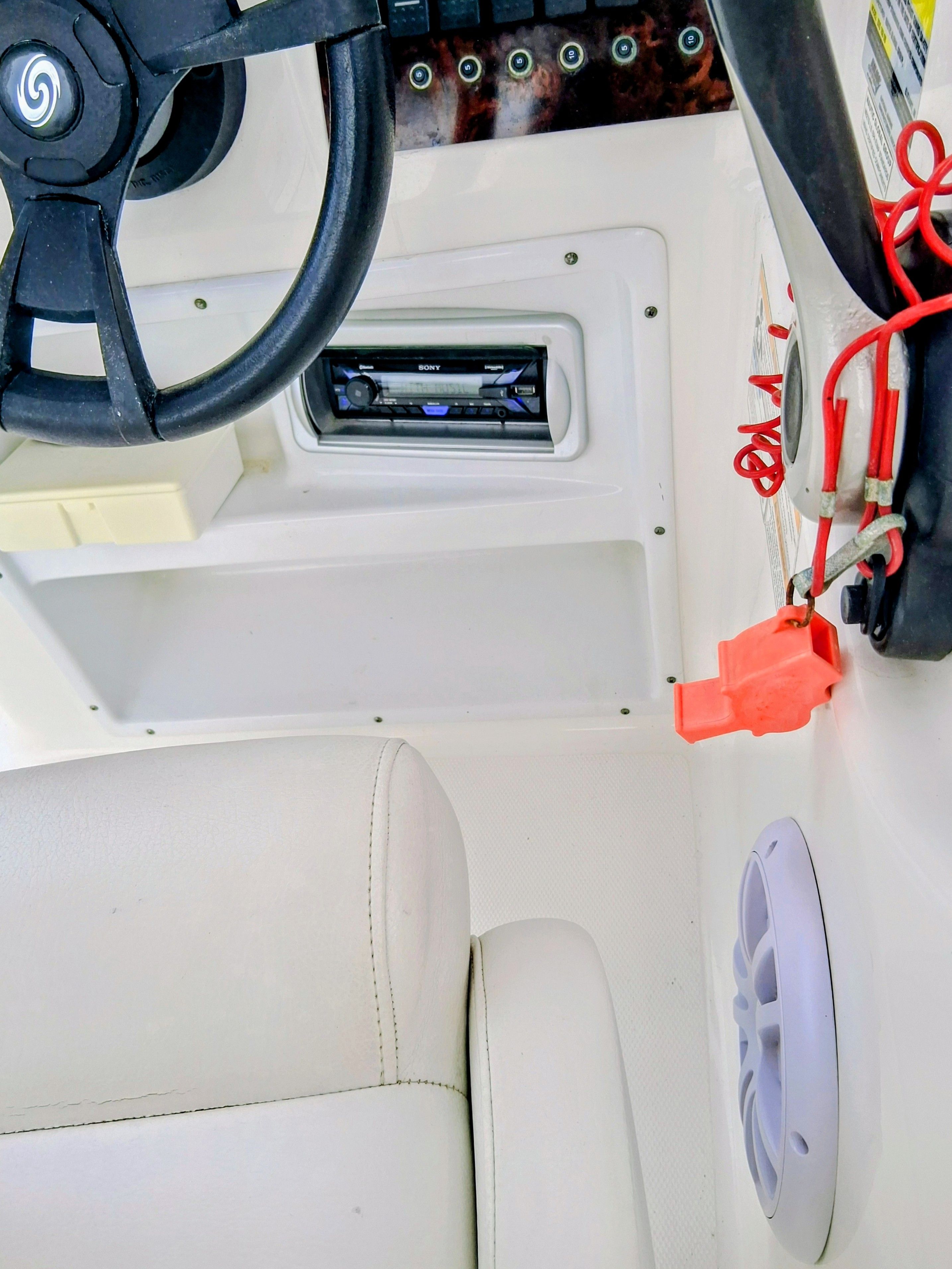 Interior of a 2013 Hurricane 188SD boat with steering wheel and radio.