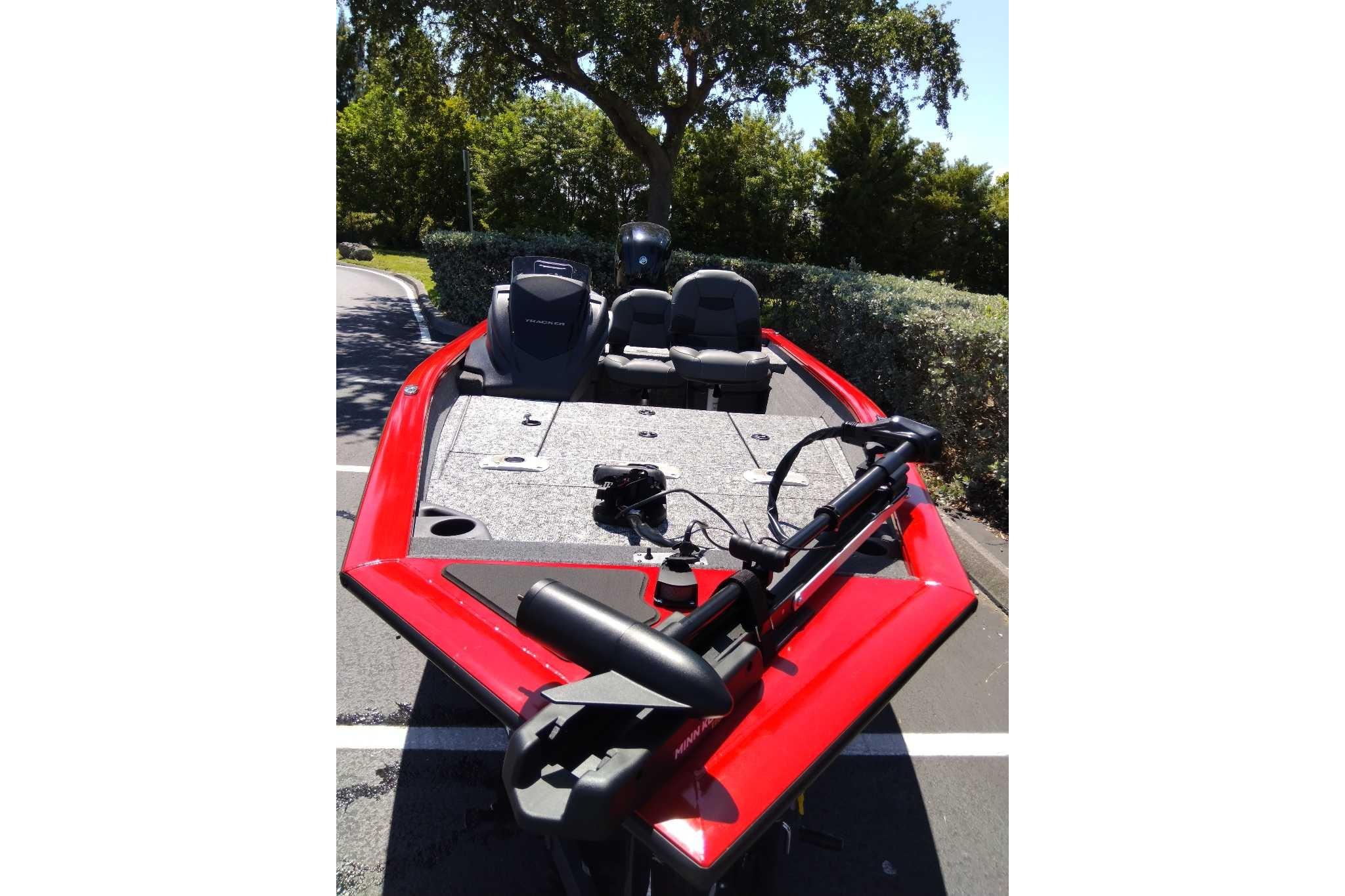 2026 Tracker Pro Team 175 Crappie Edition boat, red exterior, parked outdoors.