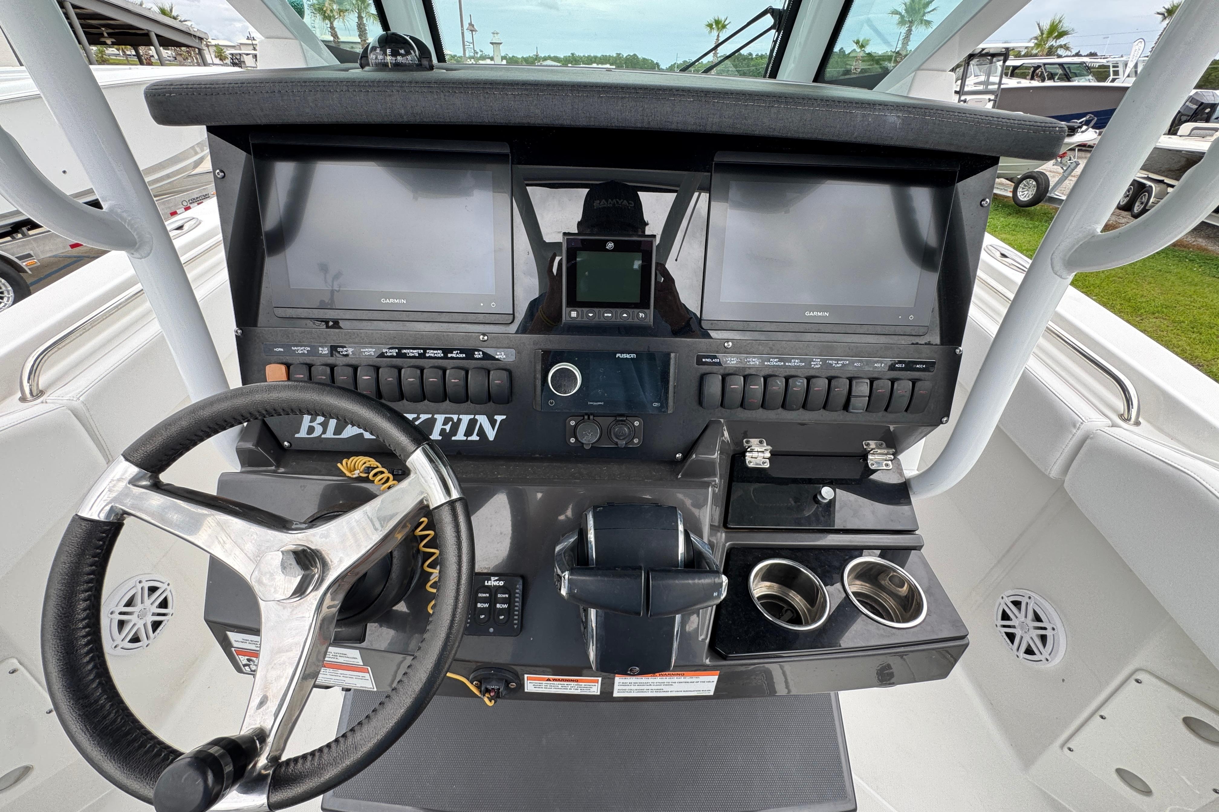 2023 Blackfin 272 CC boat dashboard with dual Garmin displays and steering wheel.