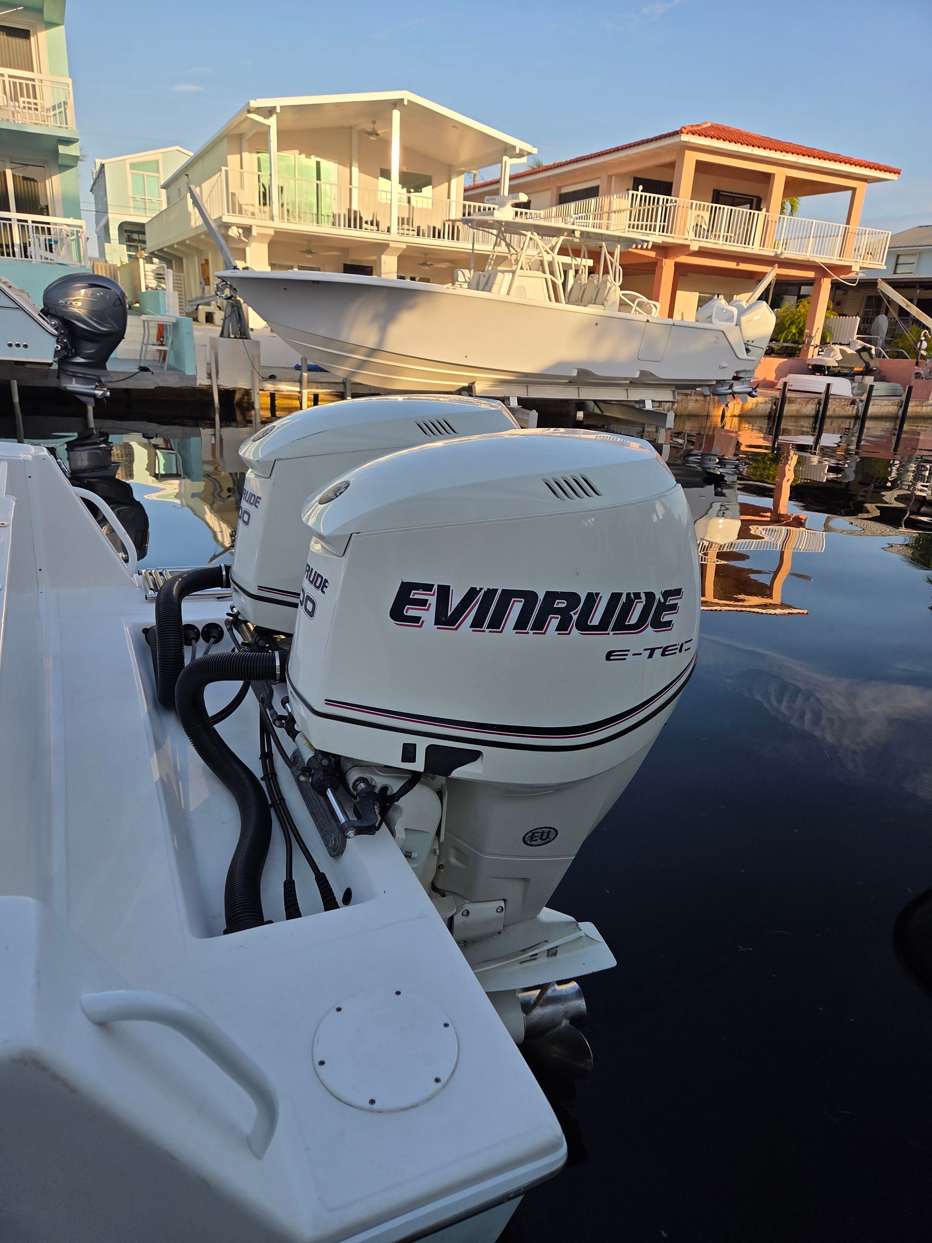 Ocean Runner 29 boat with Evinrude engines docked, year 2012.