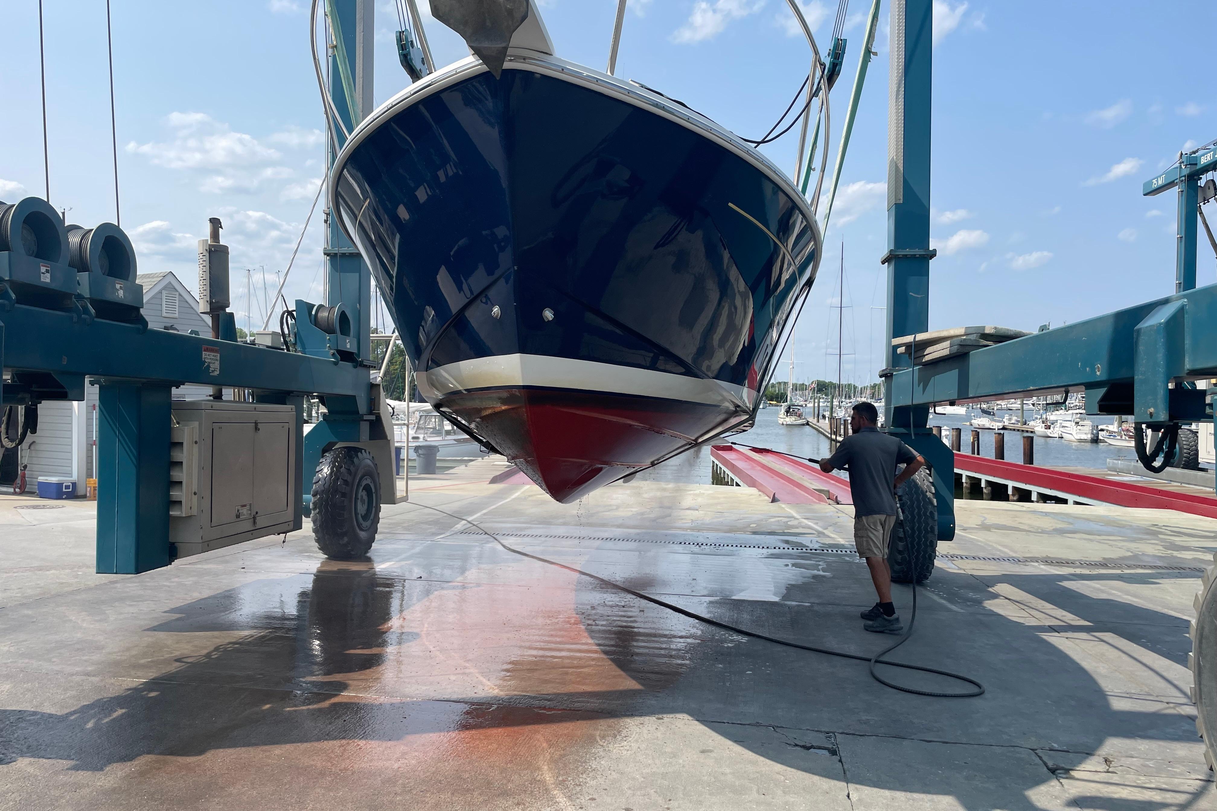 2007 Back Cove 29 boat being cleaned at a marina with a power washer.