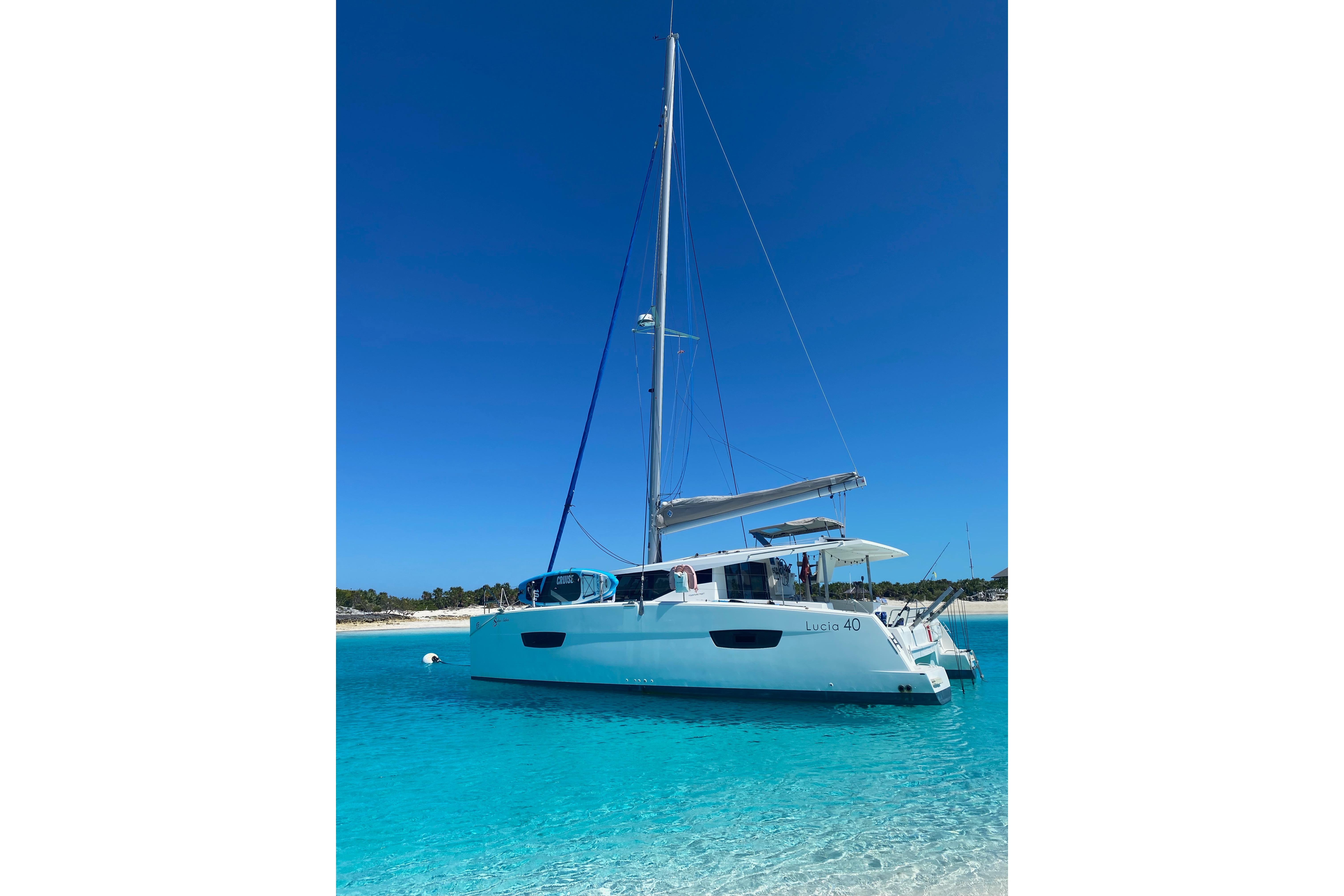 2018 Fountaine Pajot Lucia 40 catamaran anchored in clear turquoise waters.