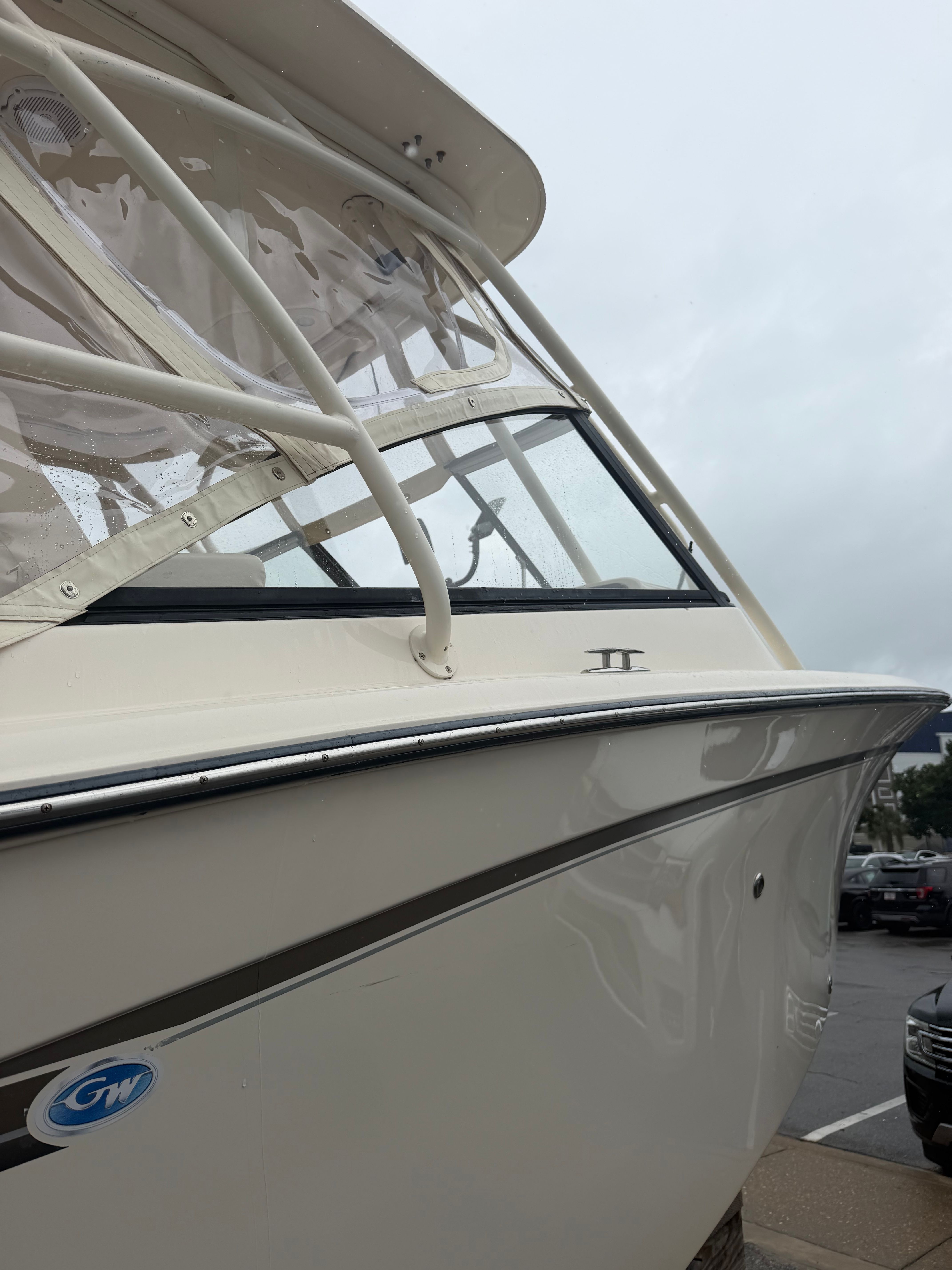 Close-up of a Grady-White Freedom 275 boat docked at a marina.