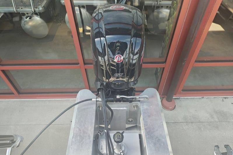 2026 Sun Tracker Fishin' Barge 20 DLX outboard motor, black, viewed from above.