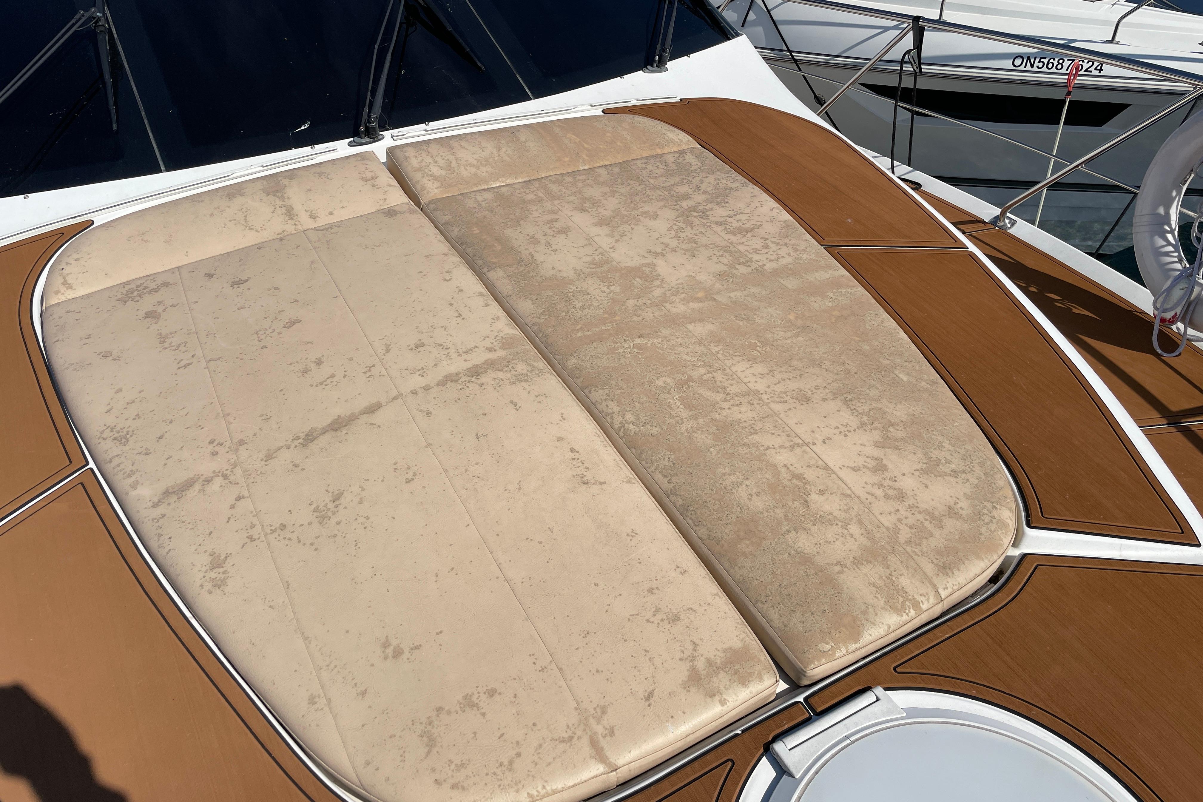 Cushioned deck area on 2002 Carver 570 Voyager Pilothouse yacht, featuring beige upholstery.
