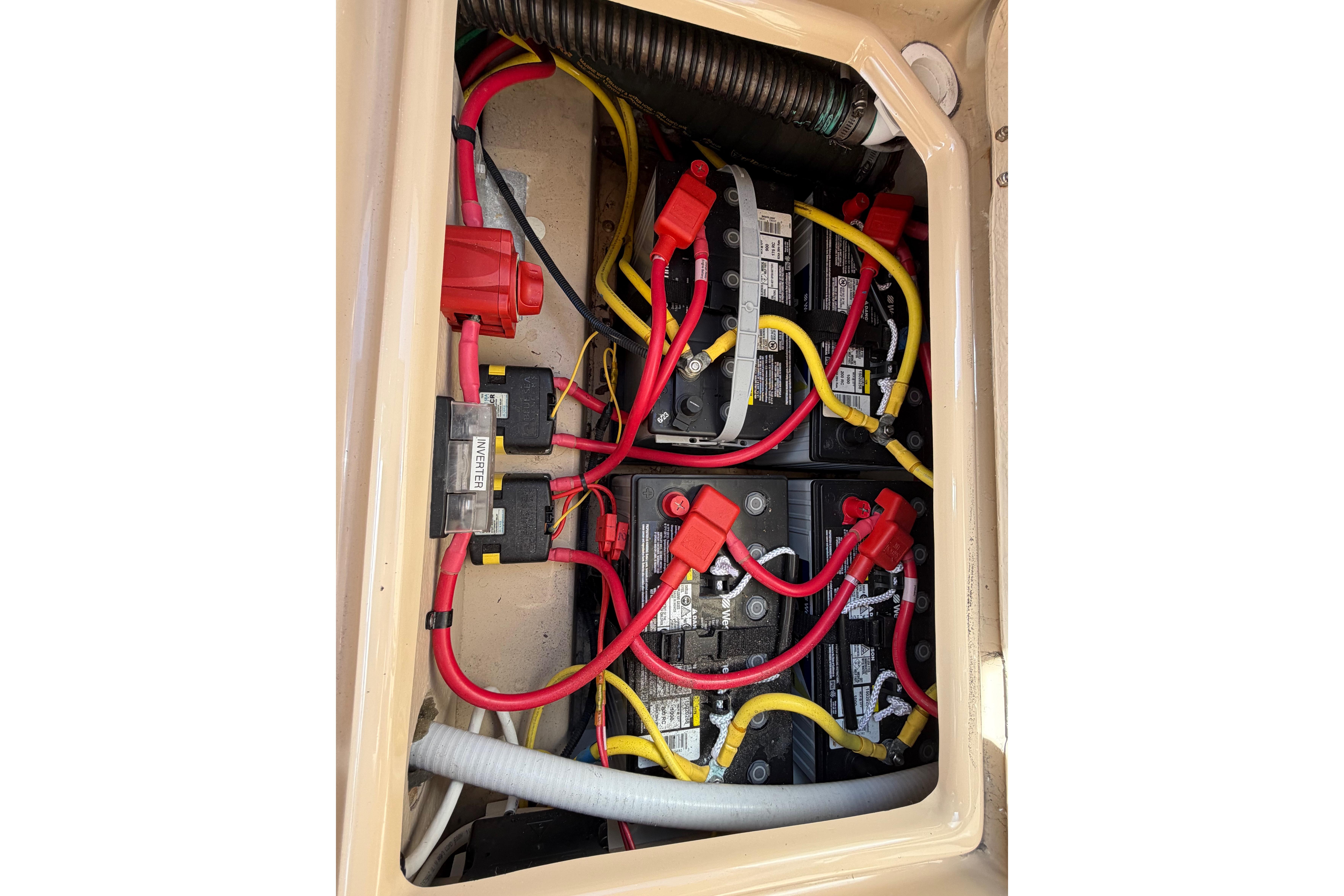 Battery compartment of a 2017 Ranger Tugs R-27 with red and yellow cables.