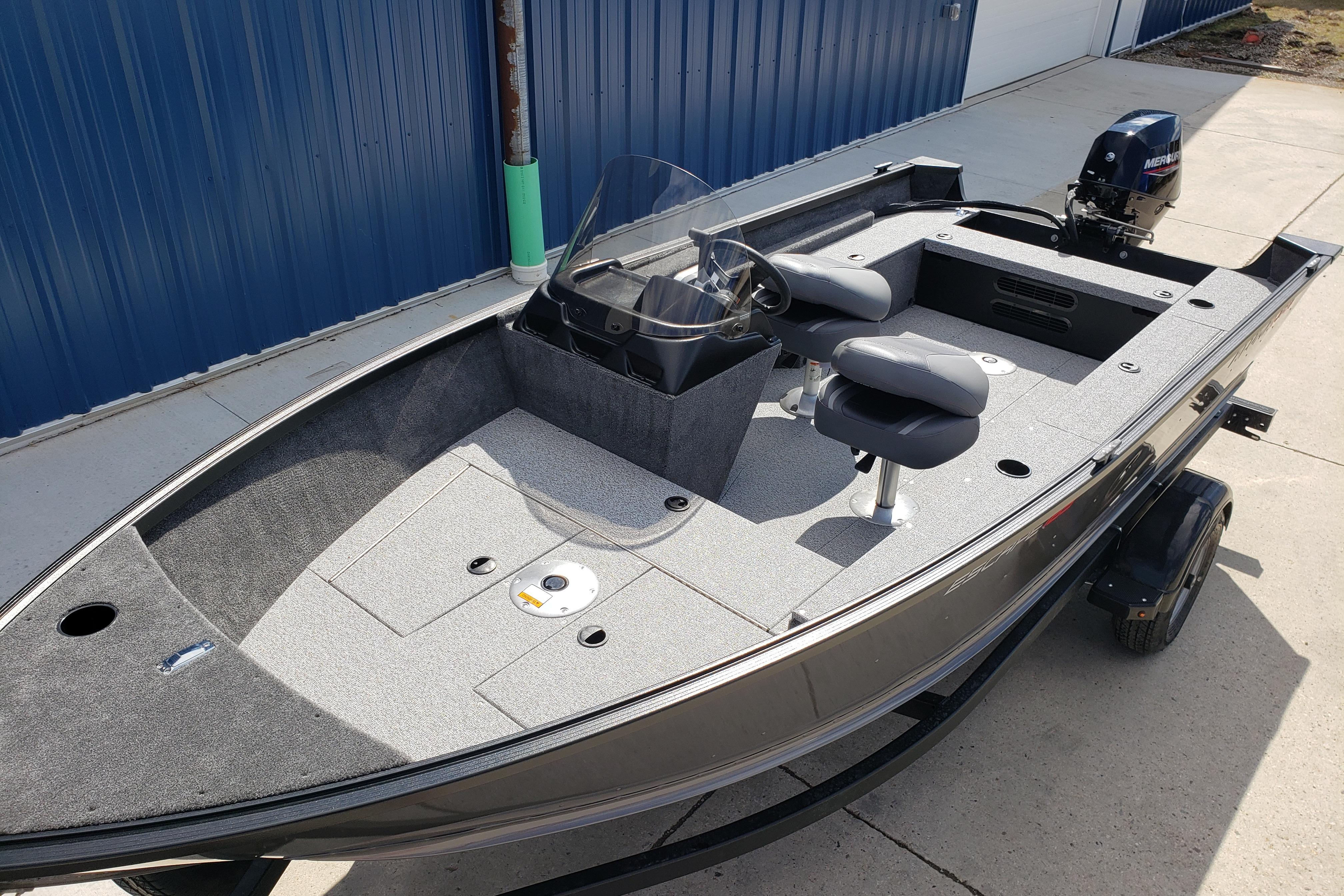 2026 Alumacraft Escape 165 CS fishing boat with dual seats and outboard motor.
