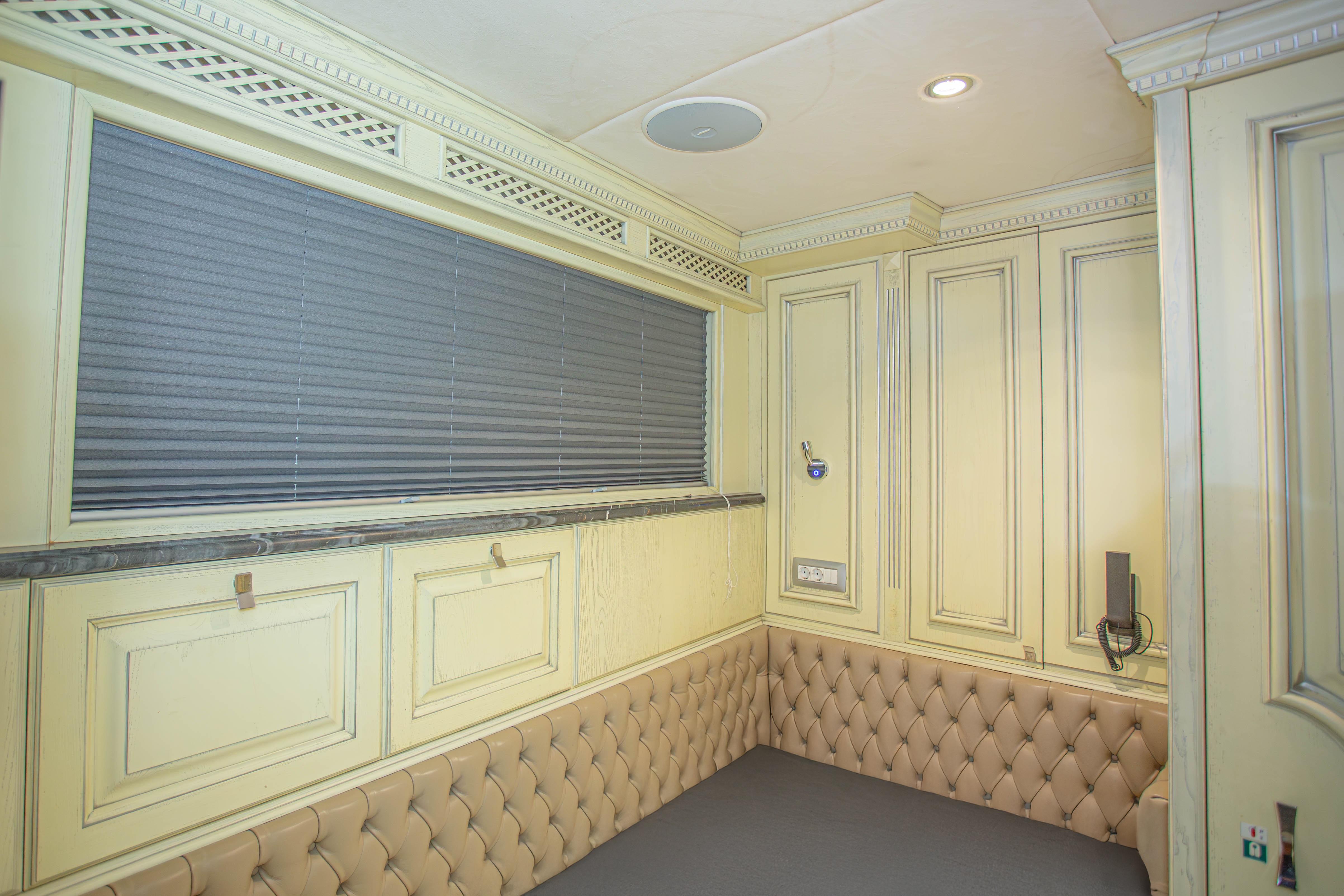 Luxurious interior of 2014 Fifth Ocean Yachts 24m Explorer, featuring elegant paneling and tufted seating.
