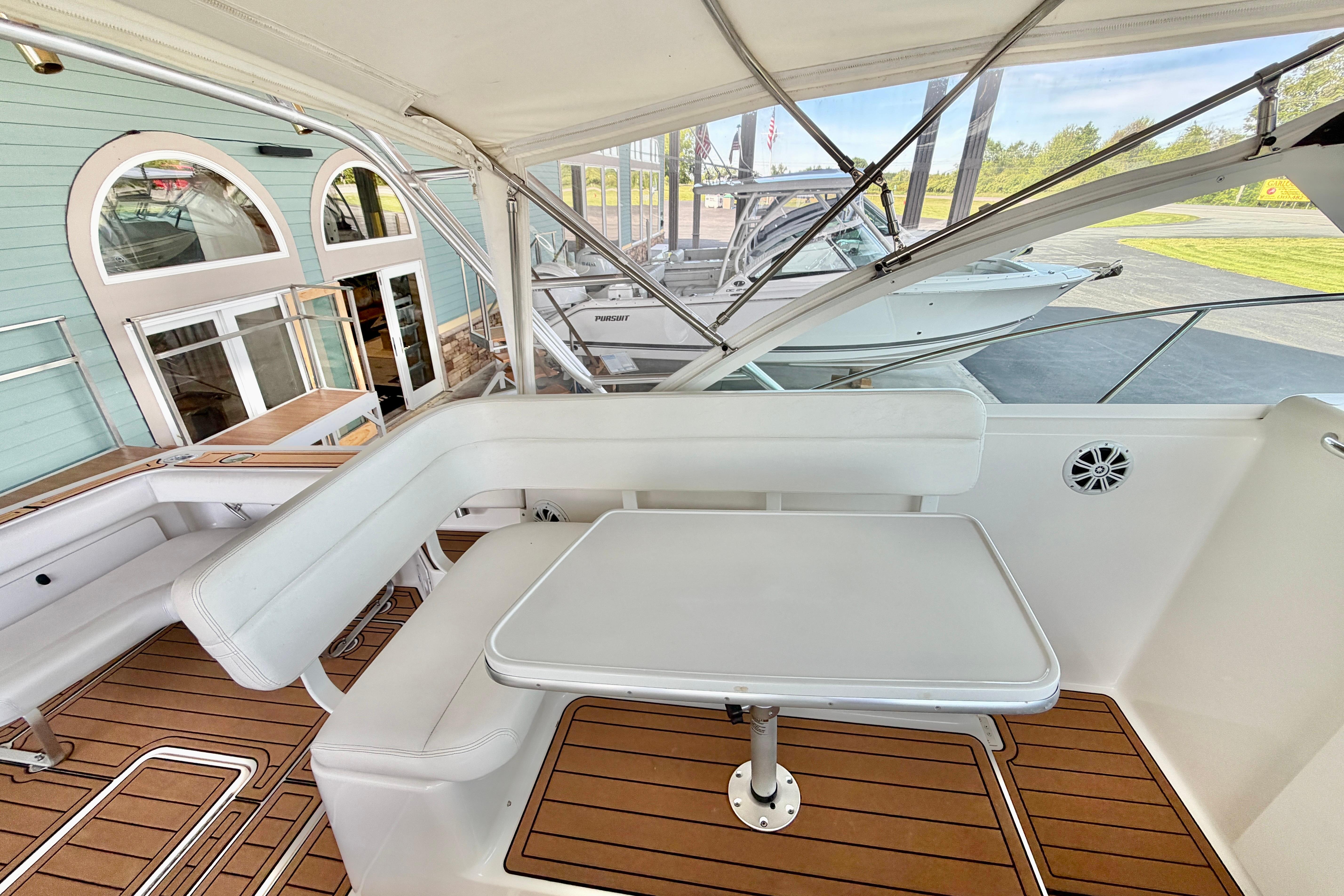 1999 Tiara Yachts 2900 Coronet interior with white seating and wooden flooring.