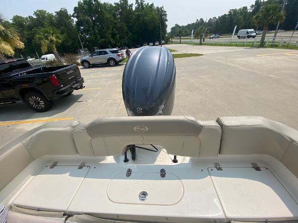 2024 Key West 203 FS boat with outboard motor in parking lot.