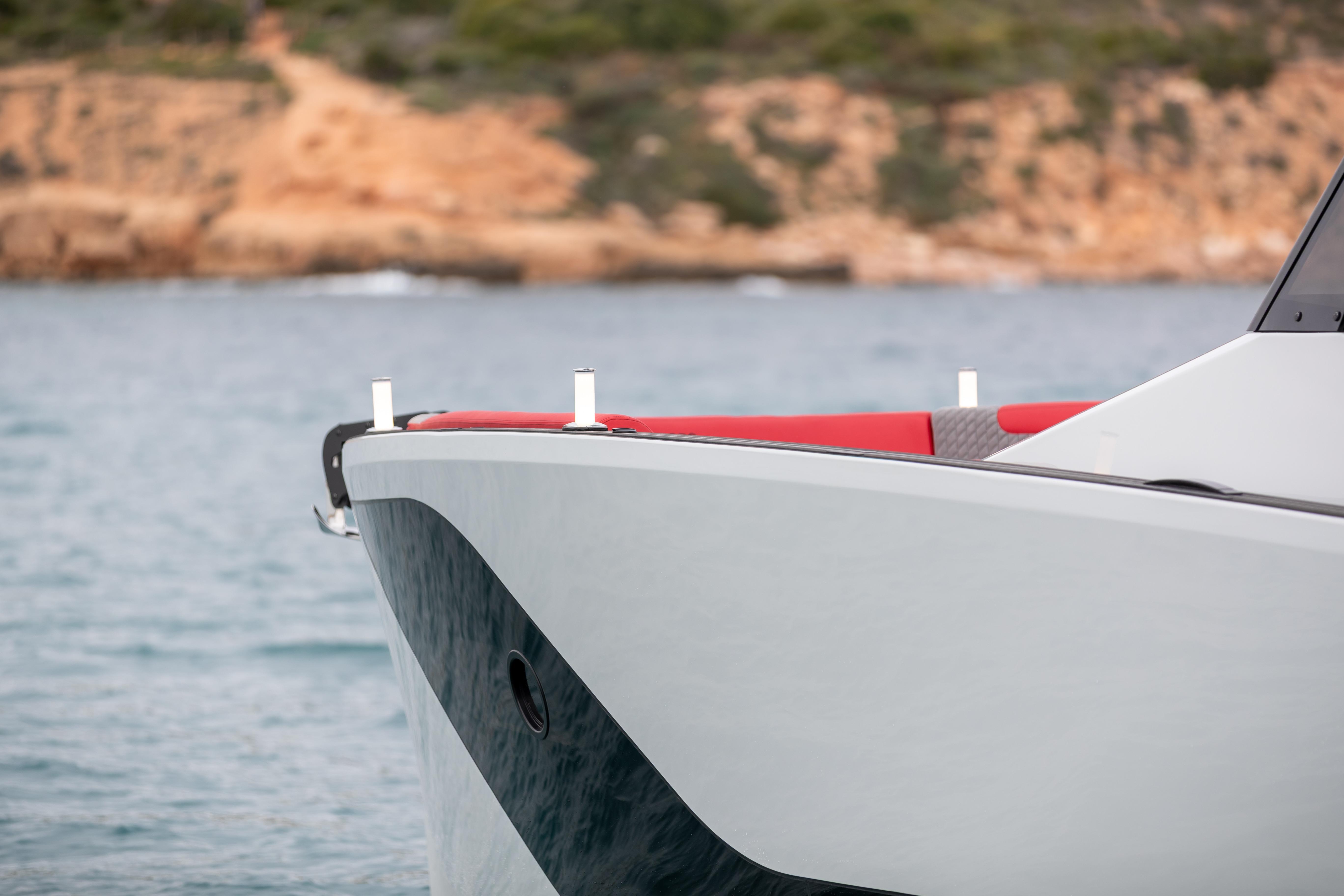 Tesoro 40 GTS 2026 yacht near rocky coastline.