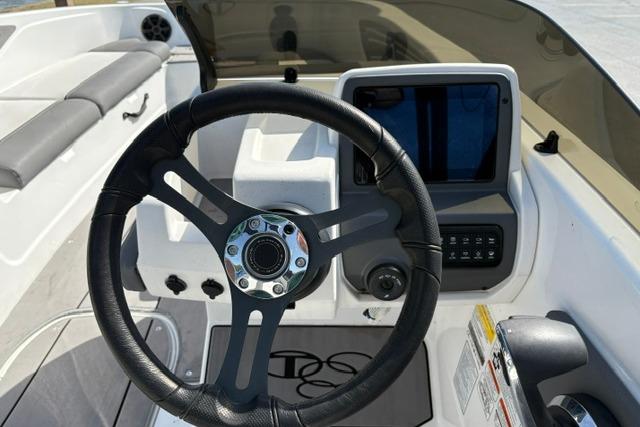 2024 Tahoe T21 boat dashboard with steering wheel and control panel.