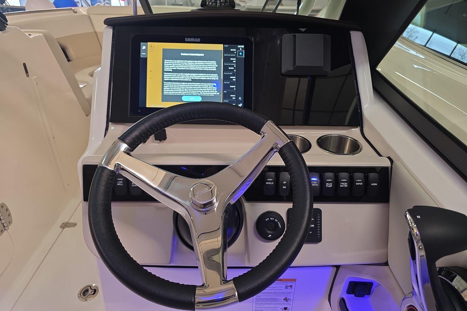 Steering console of 2025 Boston Whaler 240 Vantage with modern controls and display.