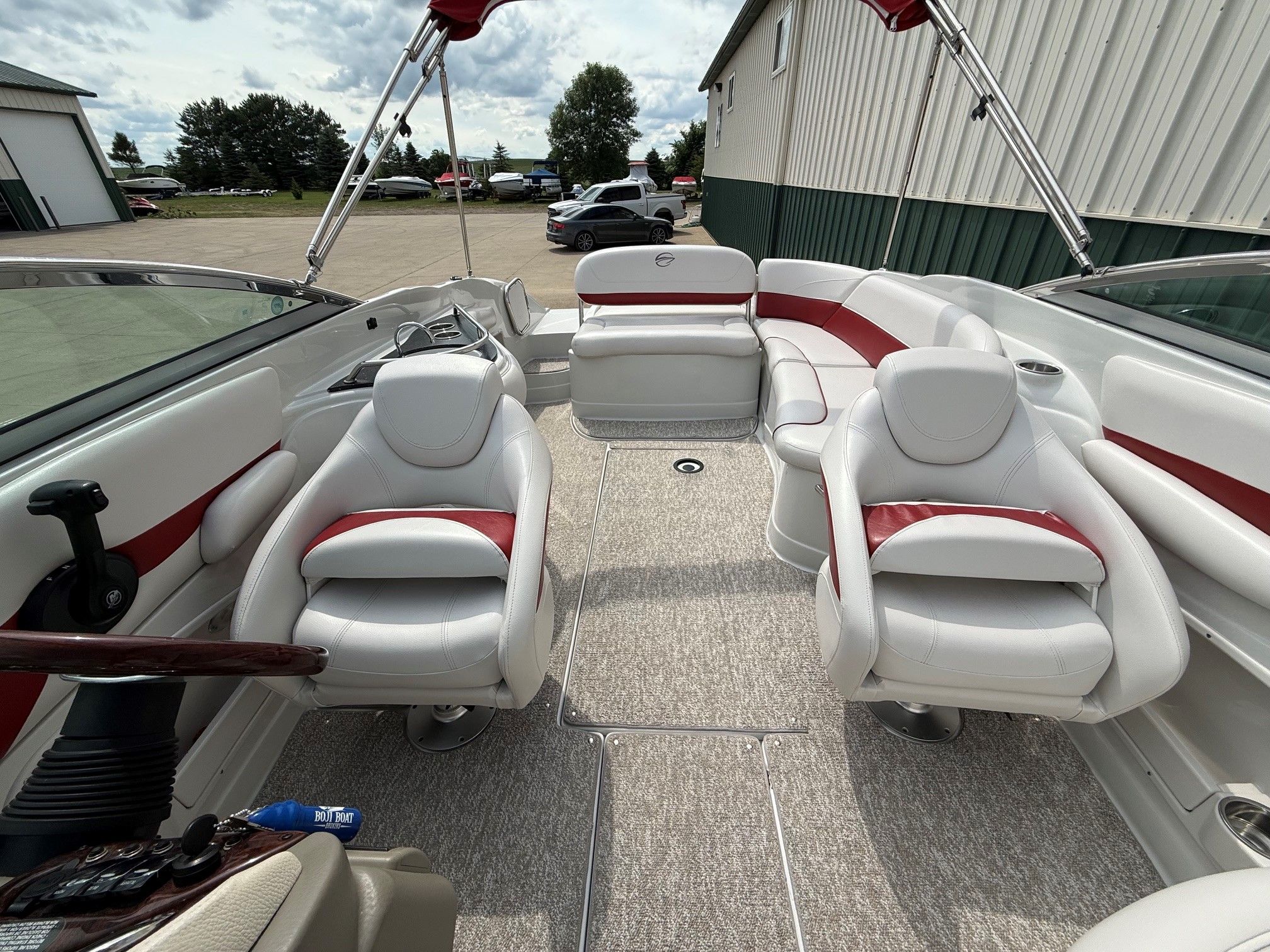 Interior of a Crownline 252 EX boat with white and red seating.