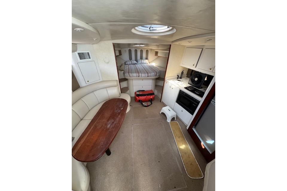 Interior of 1999 Cruisers 3870 Express yacht with kitchen, dining area, and bed.