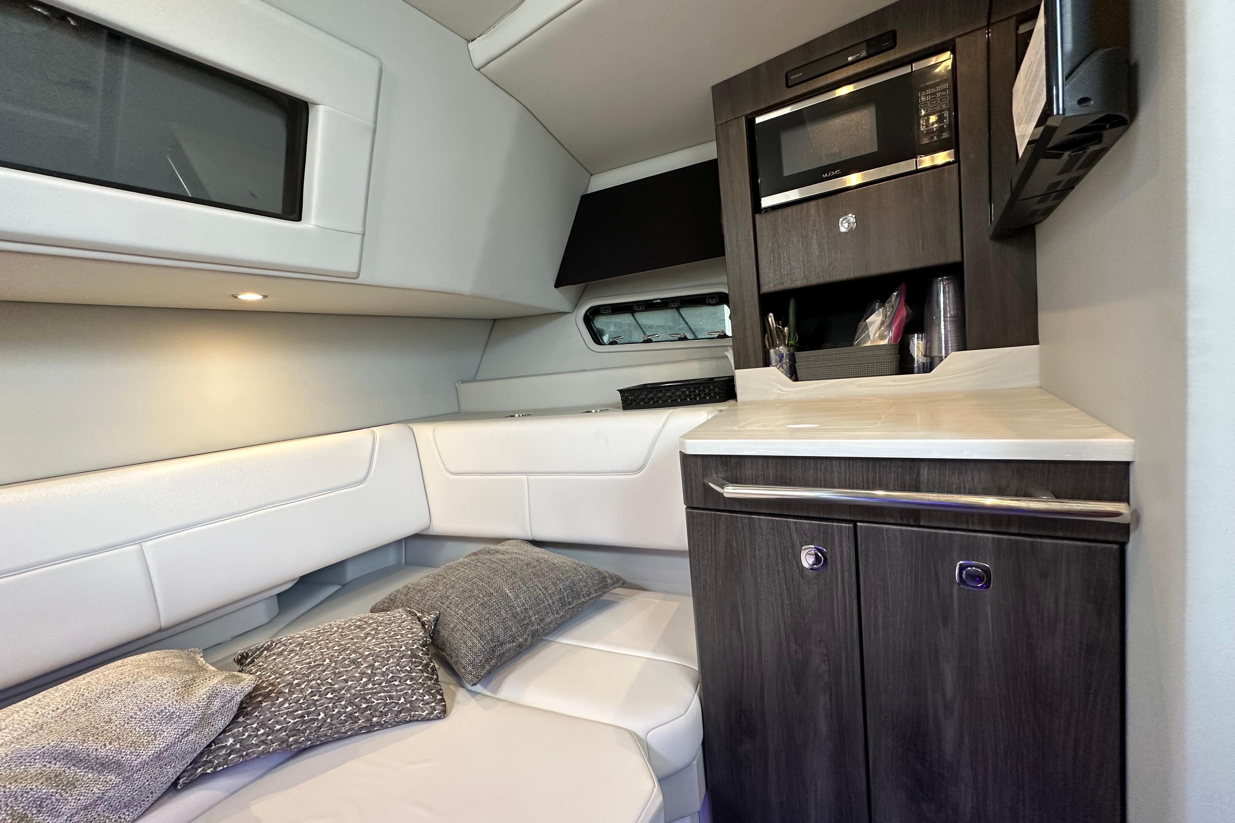 2021 Formula 380 Super Sport Crossover OB cabin interior with modern kitchenette and seating area.