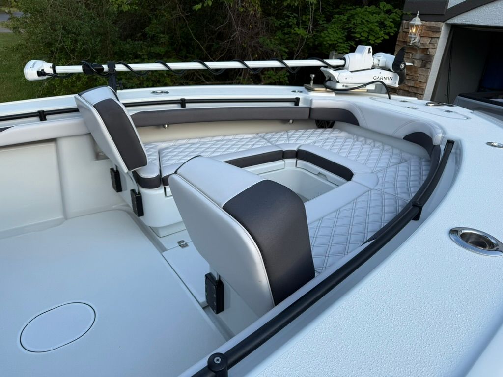 The image shows the cockpit of a 2020 Yellowfin 26 Hybrid boat with cushioned seating.