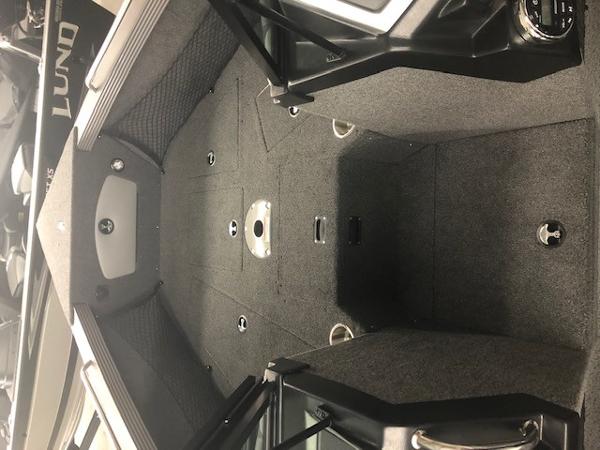 2024 Lund 2075 Tyee boat interior with spacious deck and storage compartments.
