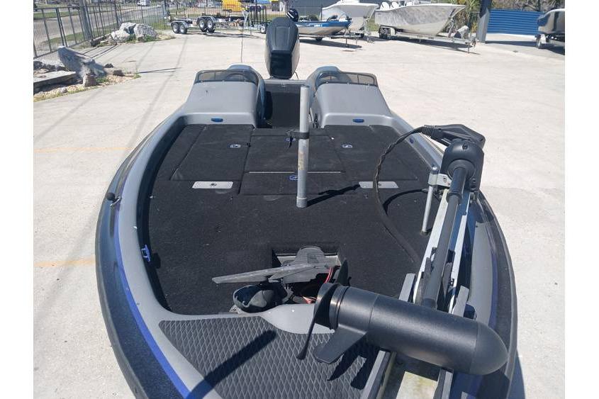 1994 Gambler 21 boat with black deck, parked outdoors, surrounded by other boats.