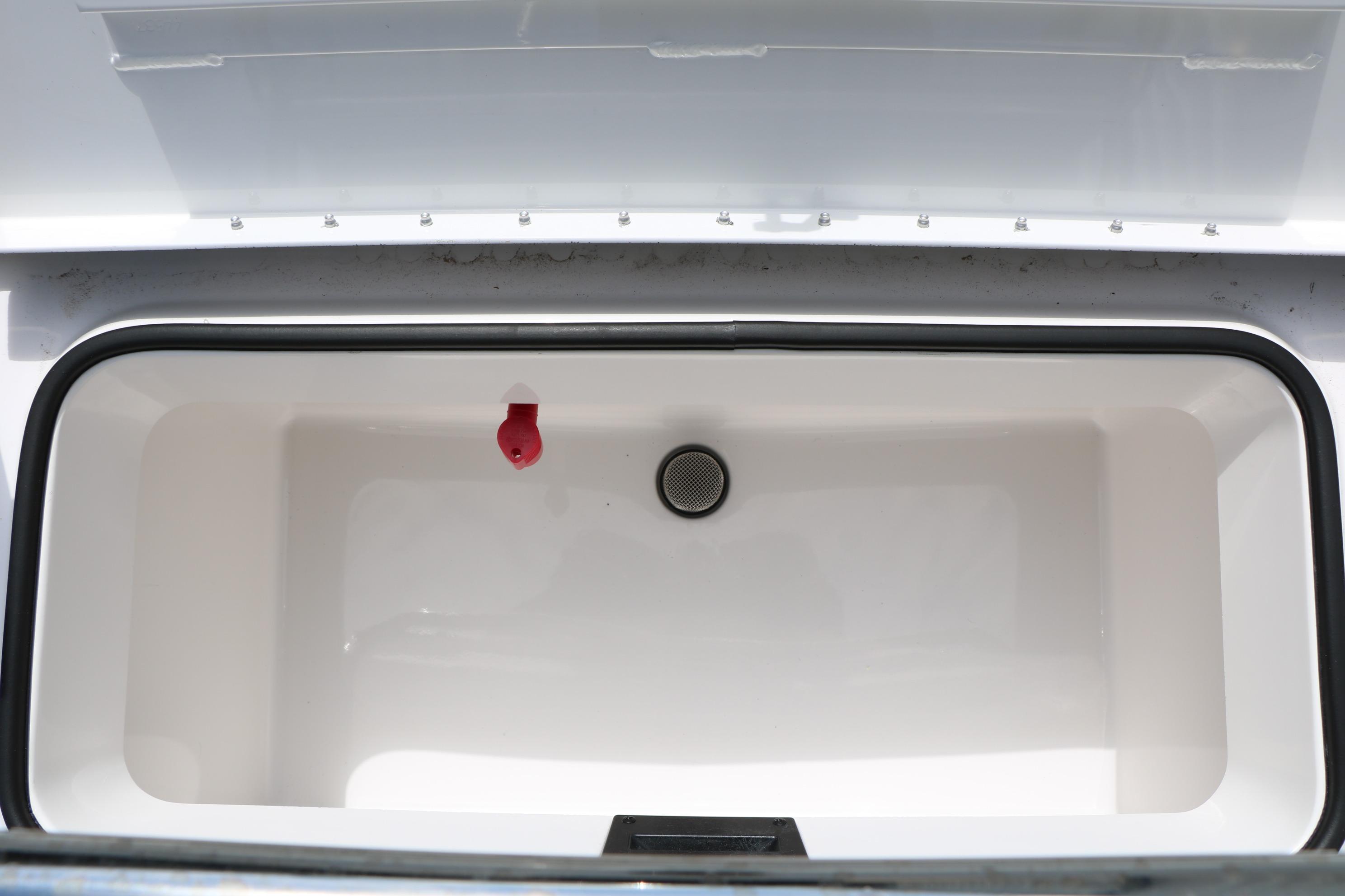 Open storage compartment in 2026 Vexus Defender 201 boat, featuring a clean interior design.