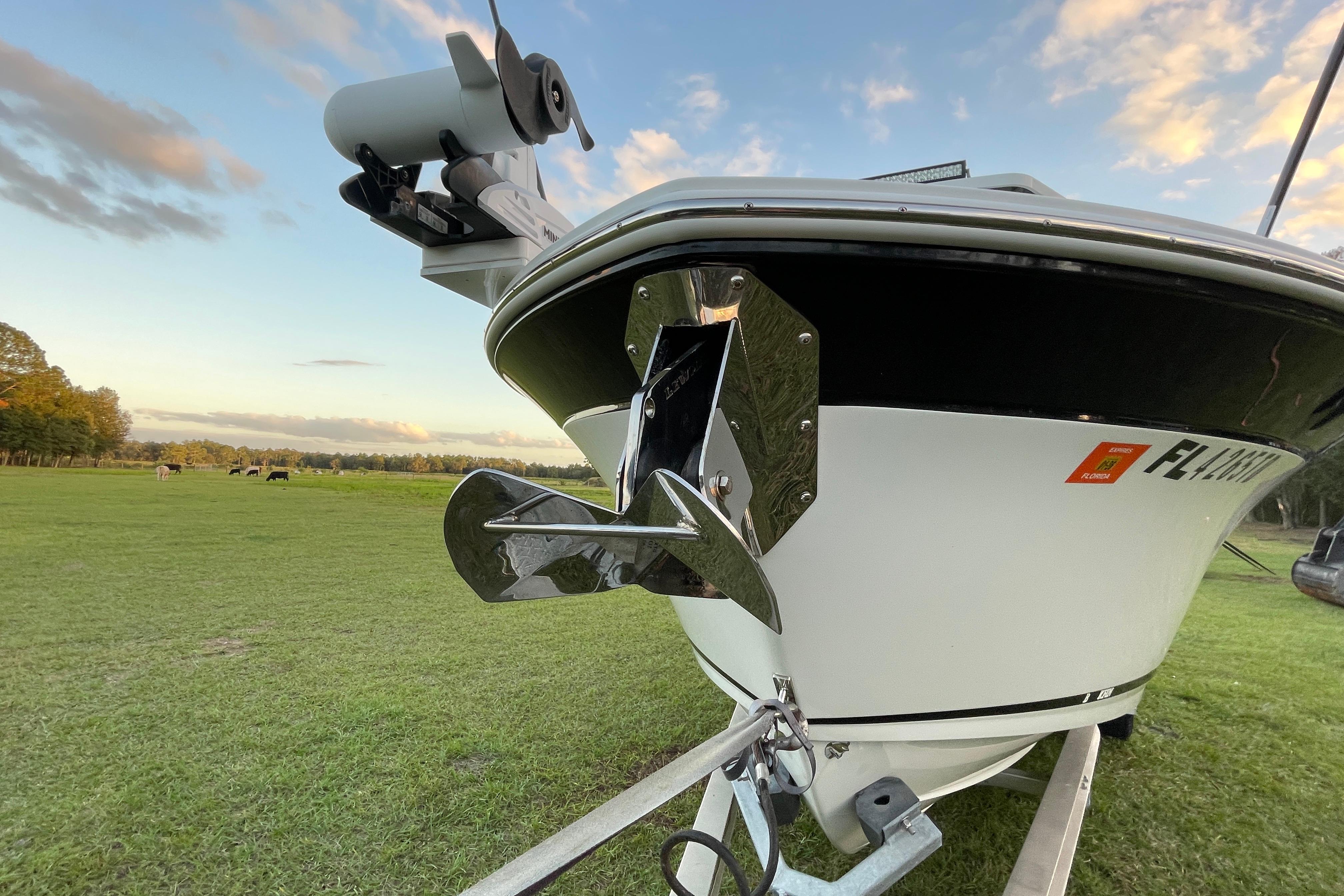 2022 Blackfin 252 CC boat on trailer, grassy field, clear sky background.